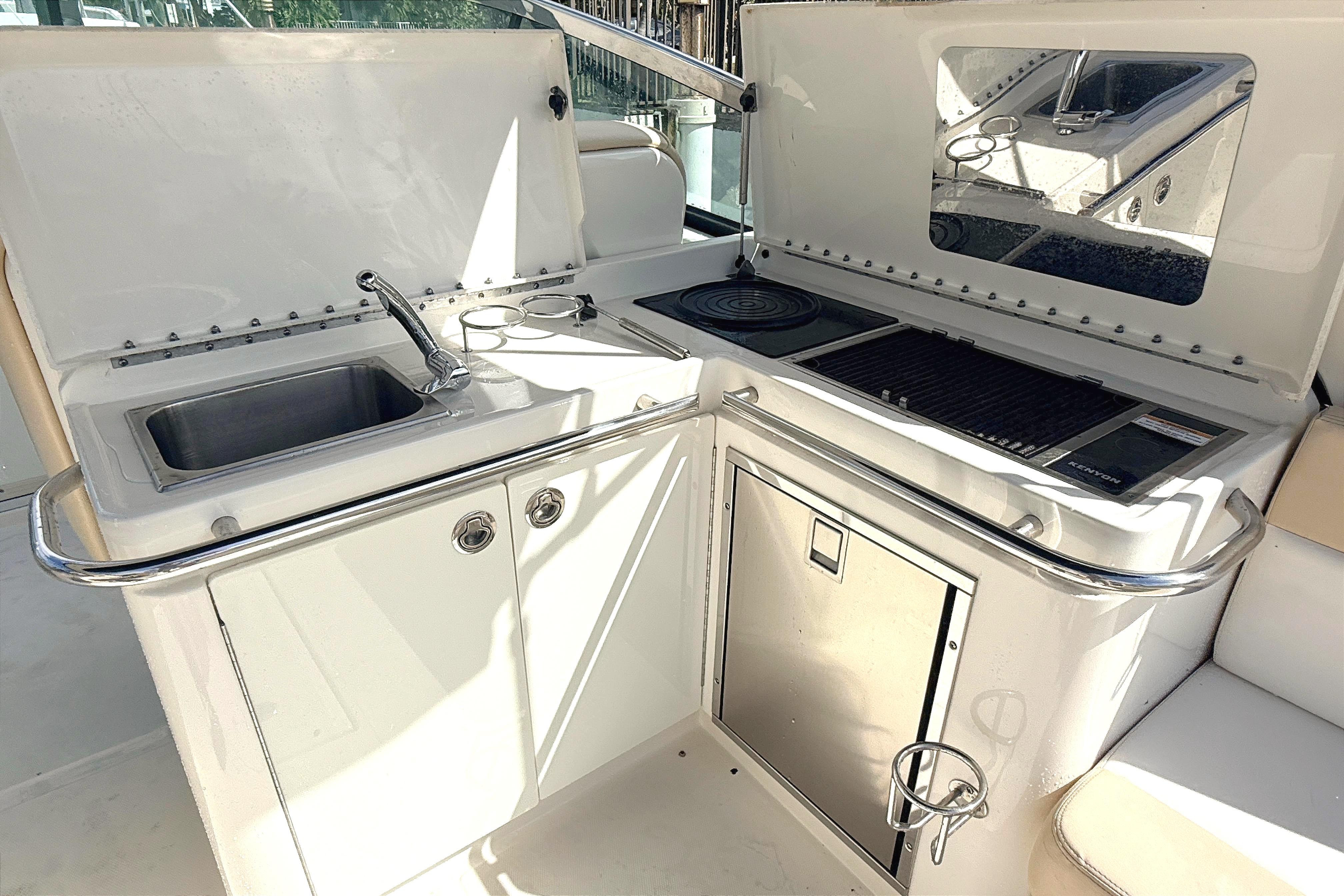 2013 Sea Ray 370 Venture boat kitchenette with sink, grill, and storage.