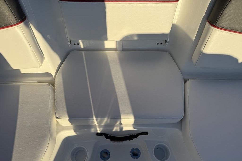 Interior seating of 2026 Tahoe T16 boat with white cushions and cup holders.