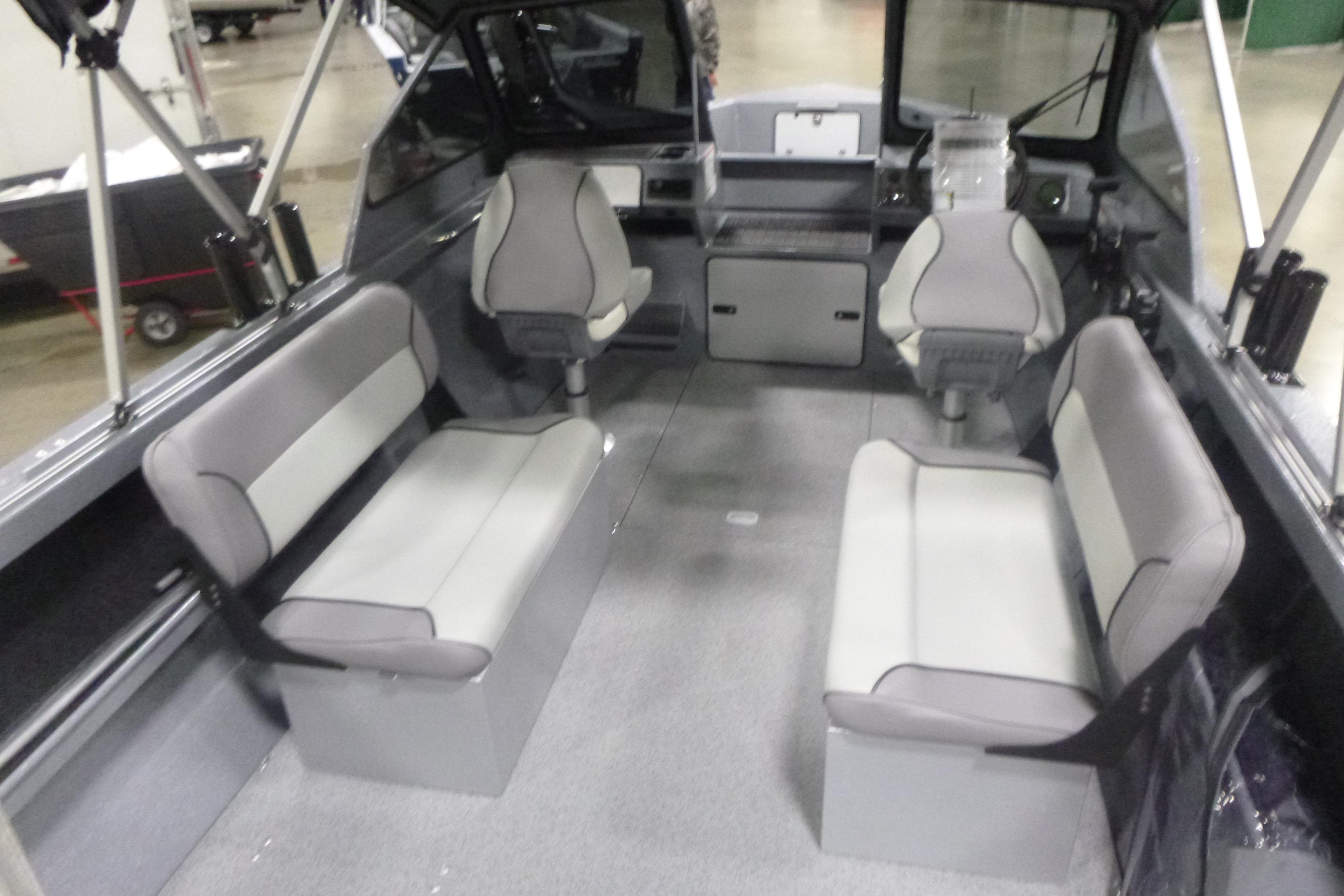 Interior of 2026 KingFisher 2025 Falcon boat with seating and steering console.