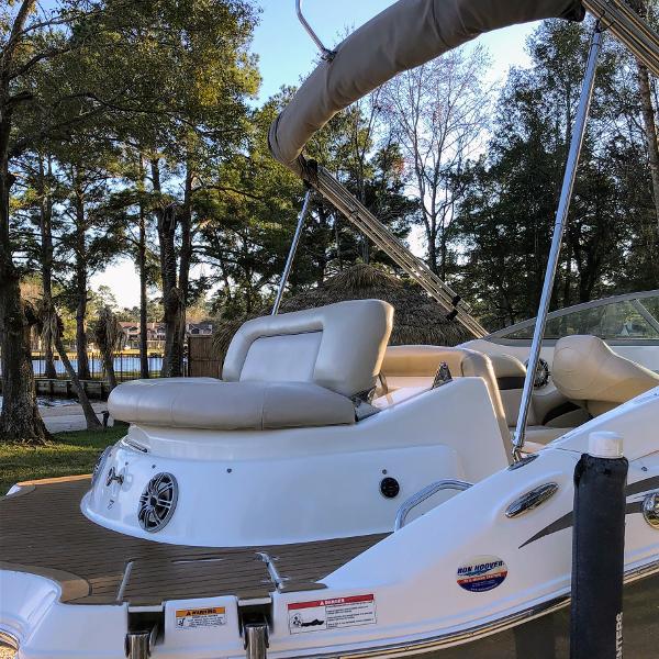 2012 Godfrey Hurricane boat with beige seats and bimini top.