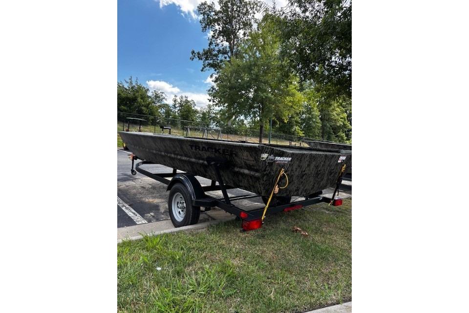 2026 Tracker Grizzly 1860 Utility boat on trailer, parked outdoors.