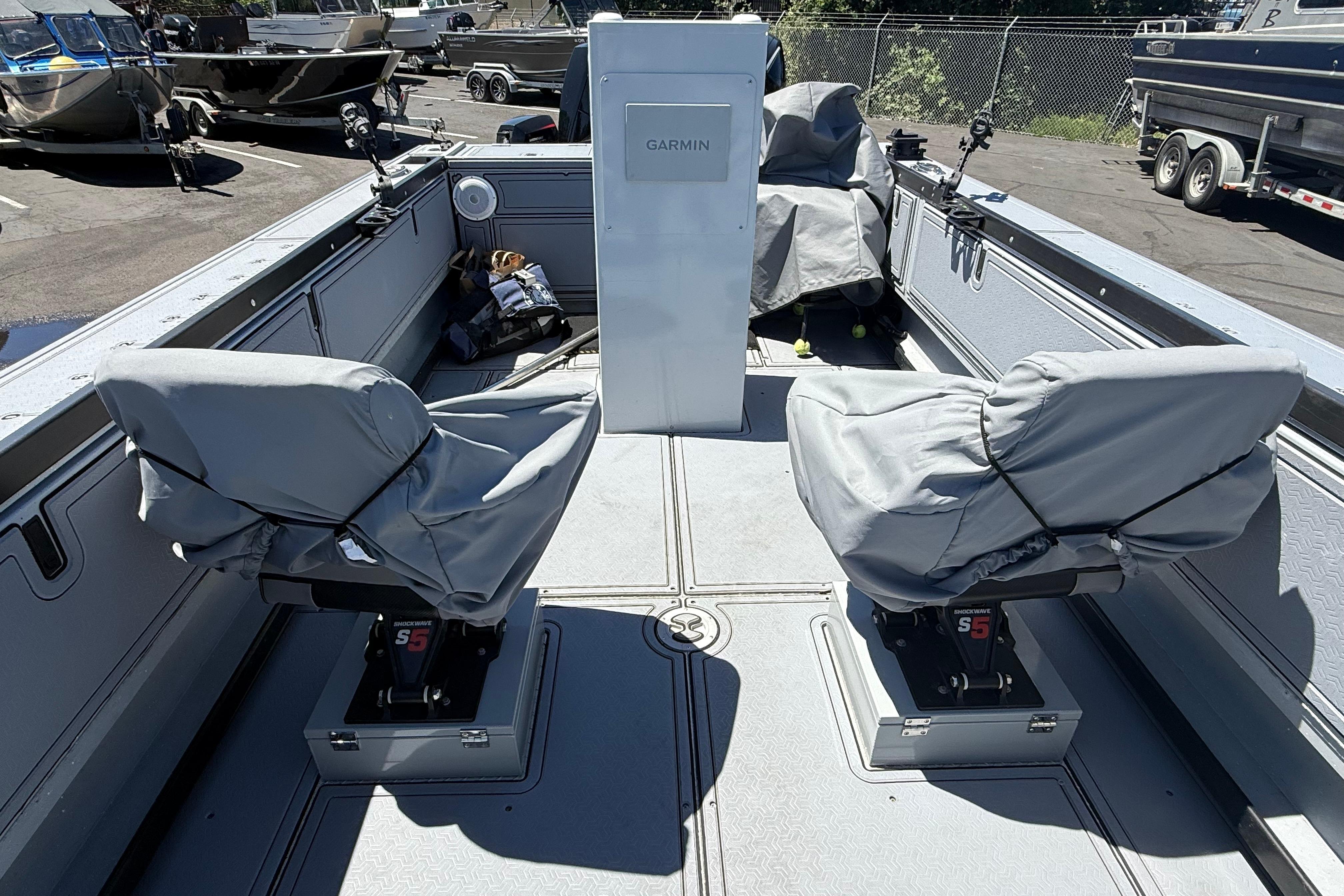 2015 Alumaweld Pacific XD 28 boat interior with covered seats and Garmin equipment.
