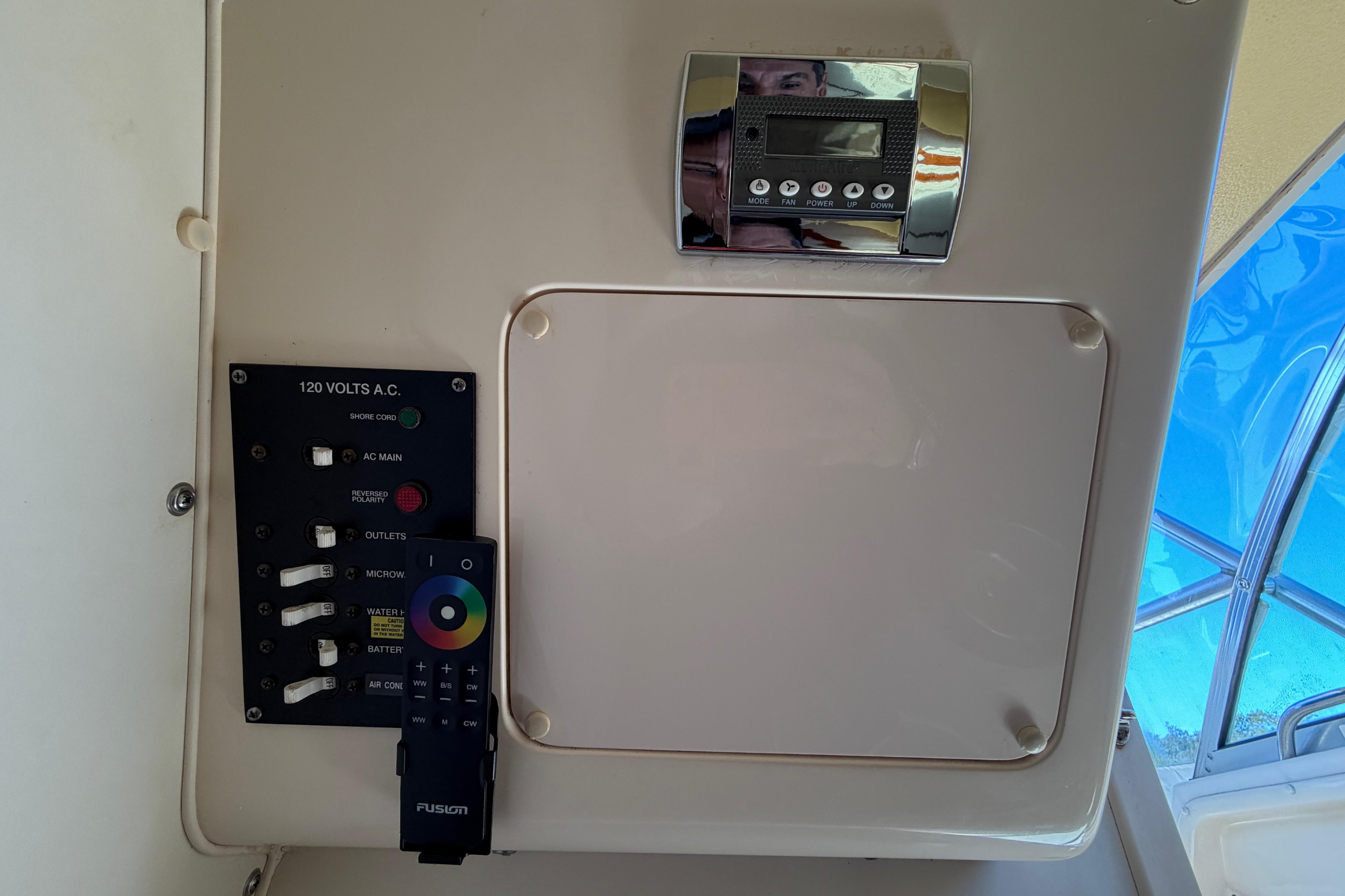 Control panel of a 2006 Grady-White Sailfish 282 boat with switches and remote.