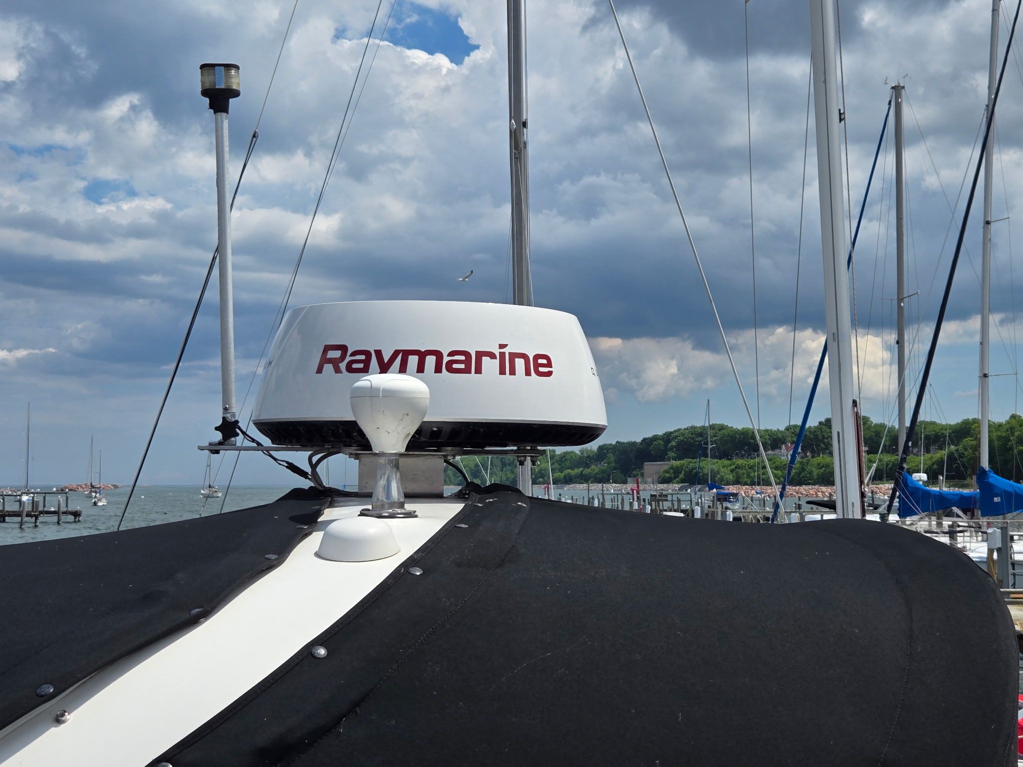 A 2006 Sea Ray 300 Sundancer with Raymarine equipment docked at a marina.