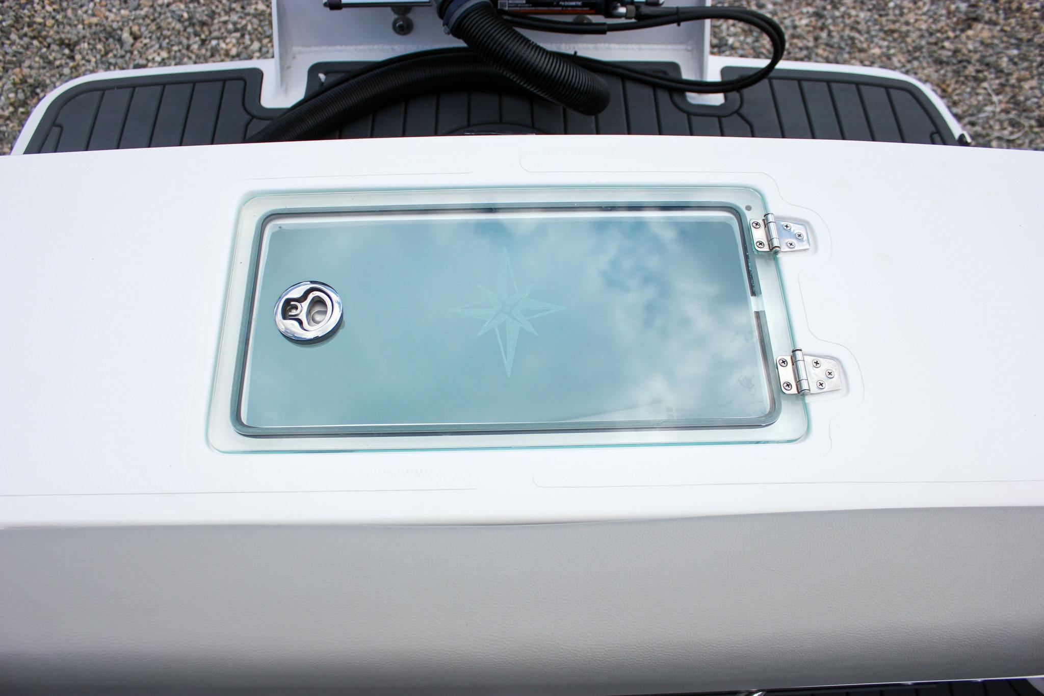 2022 NorthCoast 235 Cabin boat hatch with glass cover and stainless steel hinges.