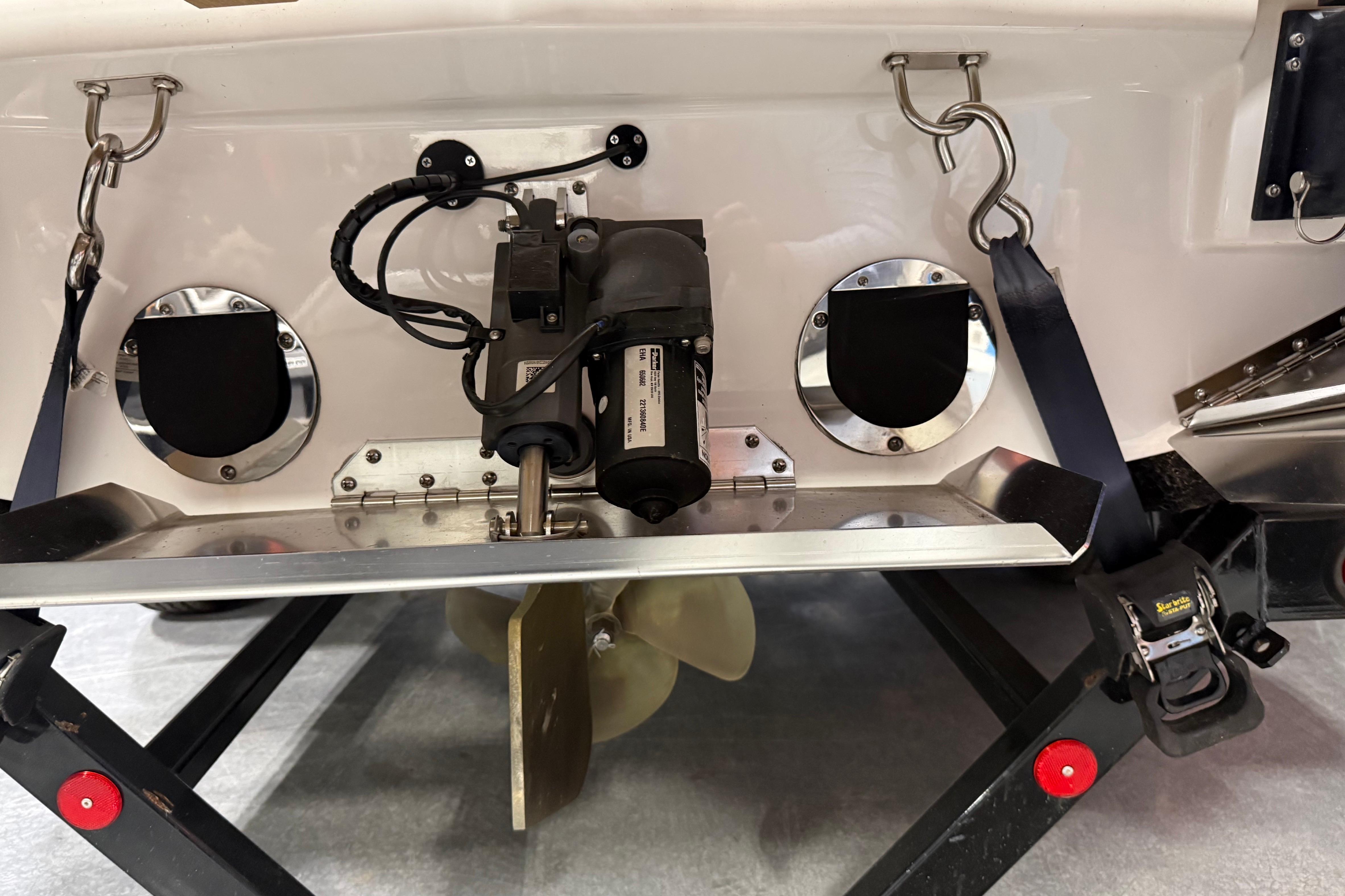 Rear view of 2022 MasterCraft NXT24 boat showing propeller and mechanical components.