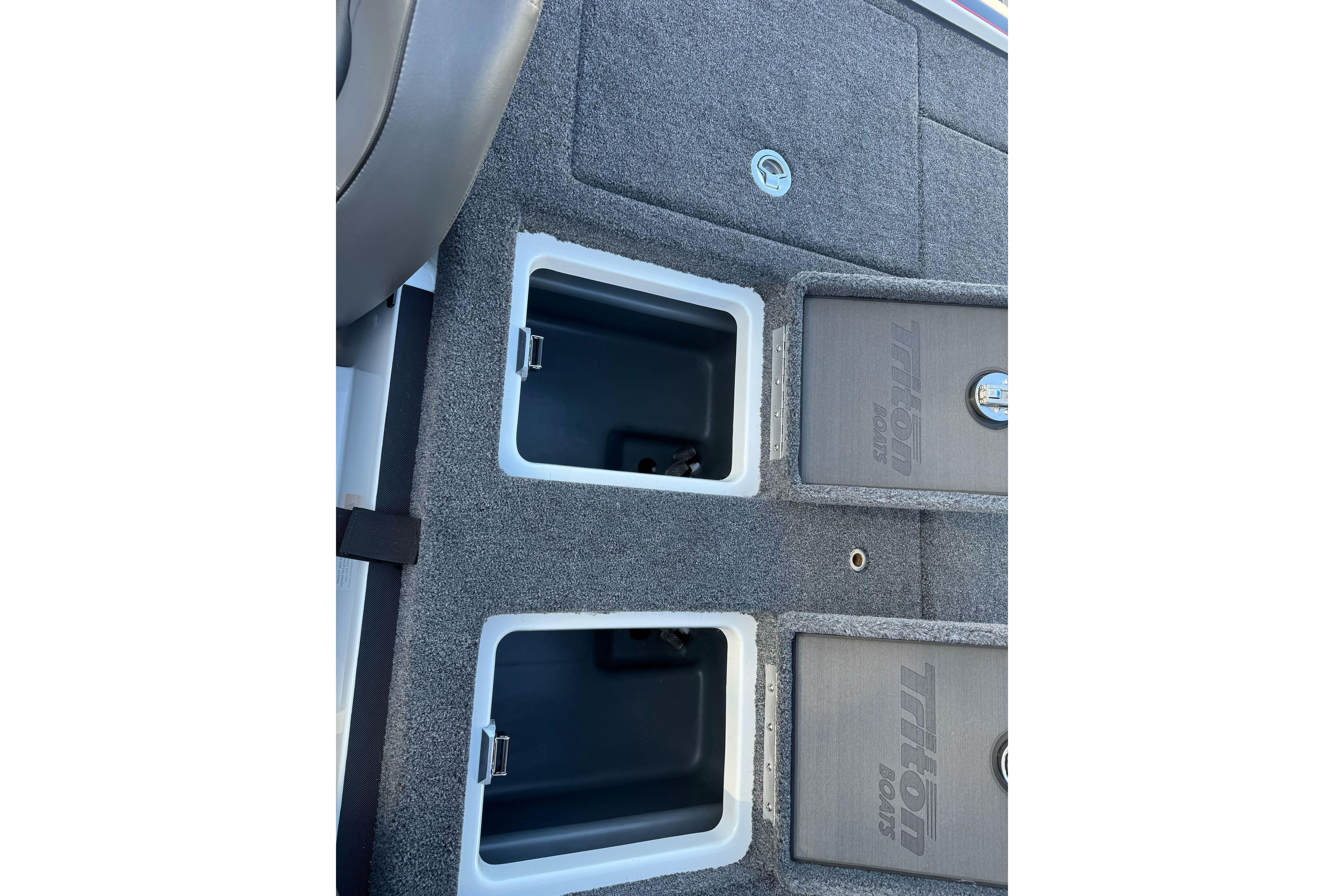 2026 Triton 20XP Patriot boat storage compartments with gray carpeted finish.