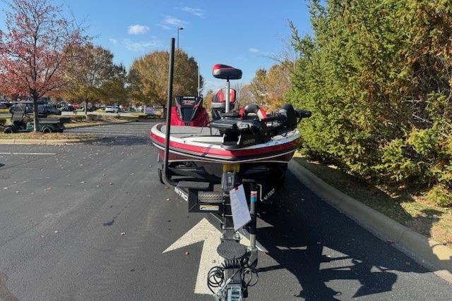 2026 Nitro Z19 XL Pro boat parked on asphalt, surrounded by autumn trees.