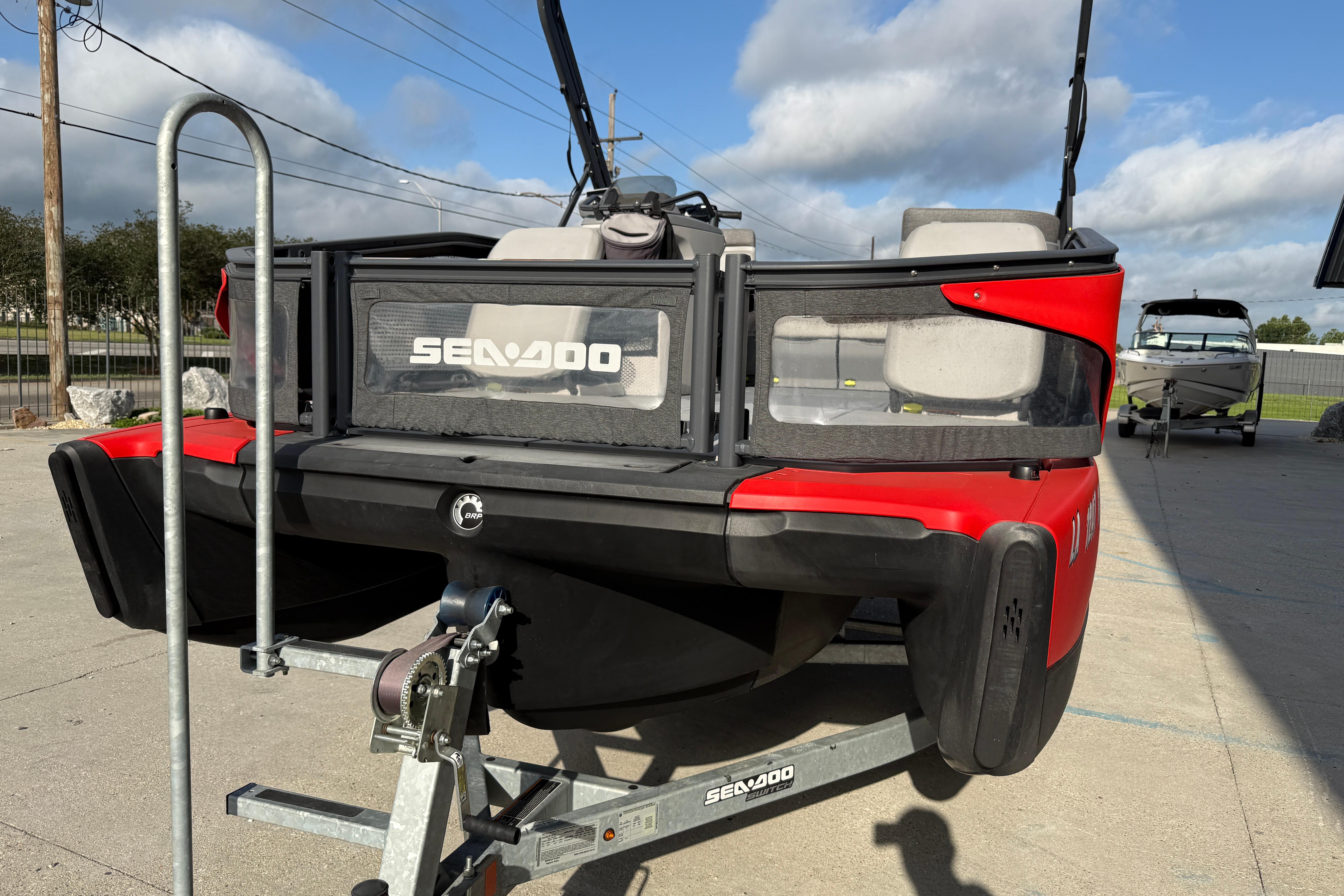 2023 Sea-Doo Switch Sport 18 on trailer, red and black design, outdoor setting.