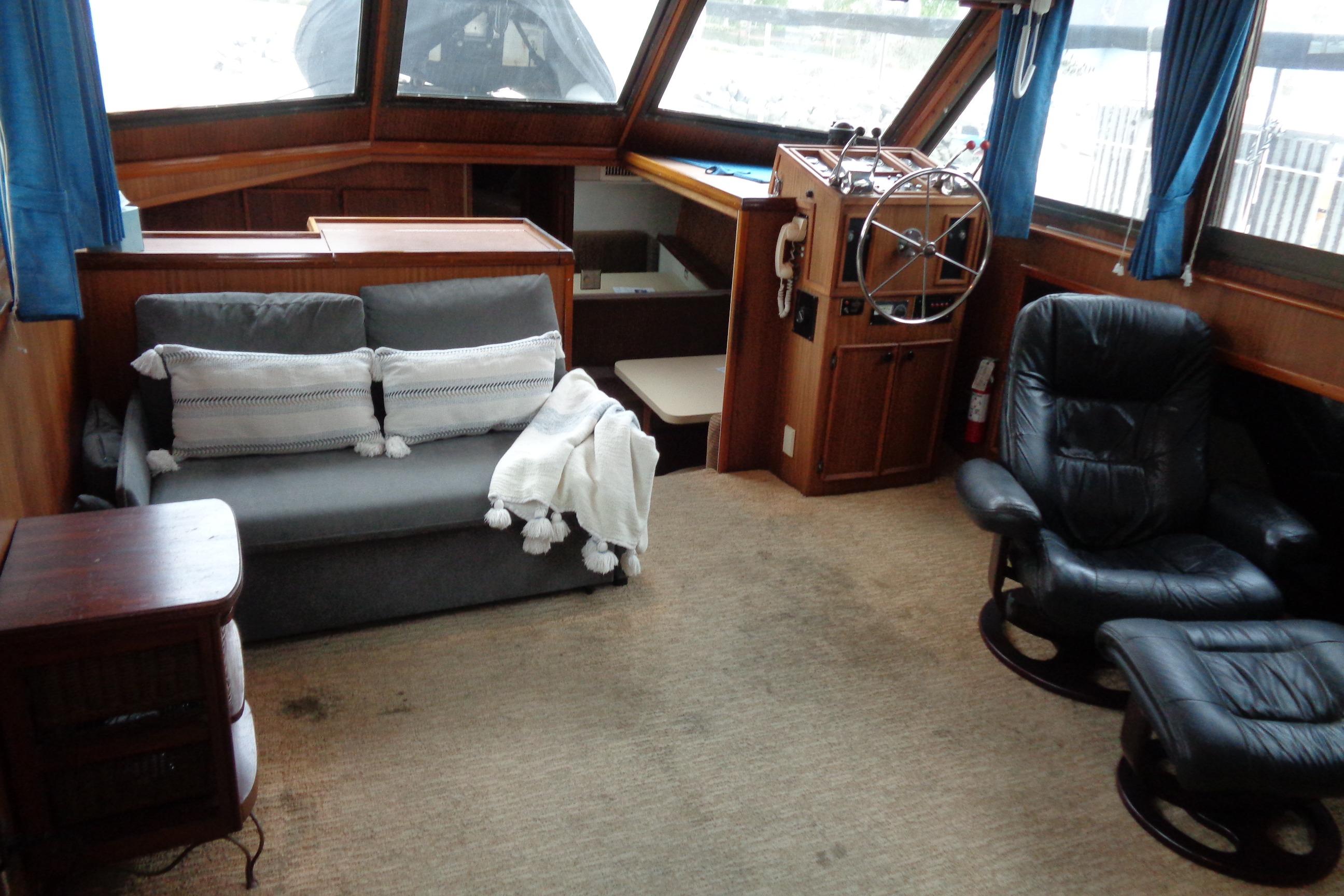 Interior of 1981 Hatteras 48 Cockpit Motor Yacht with seating and helm station.