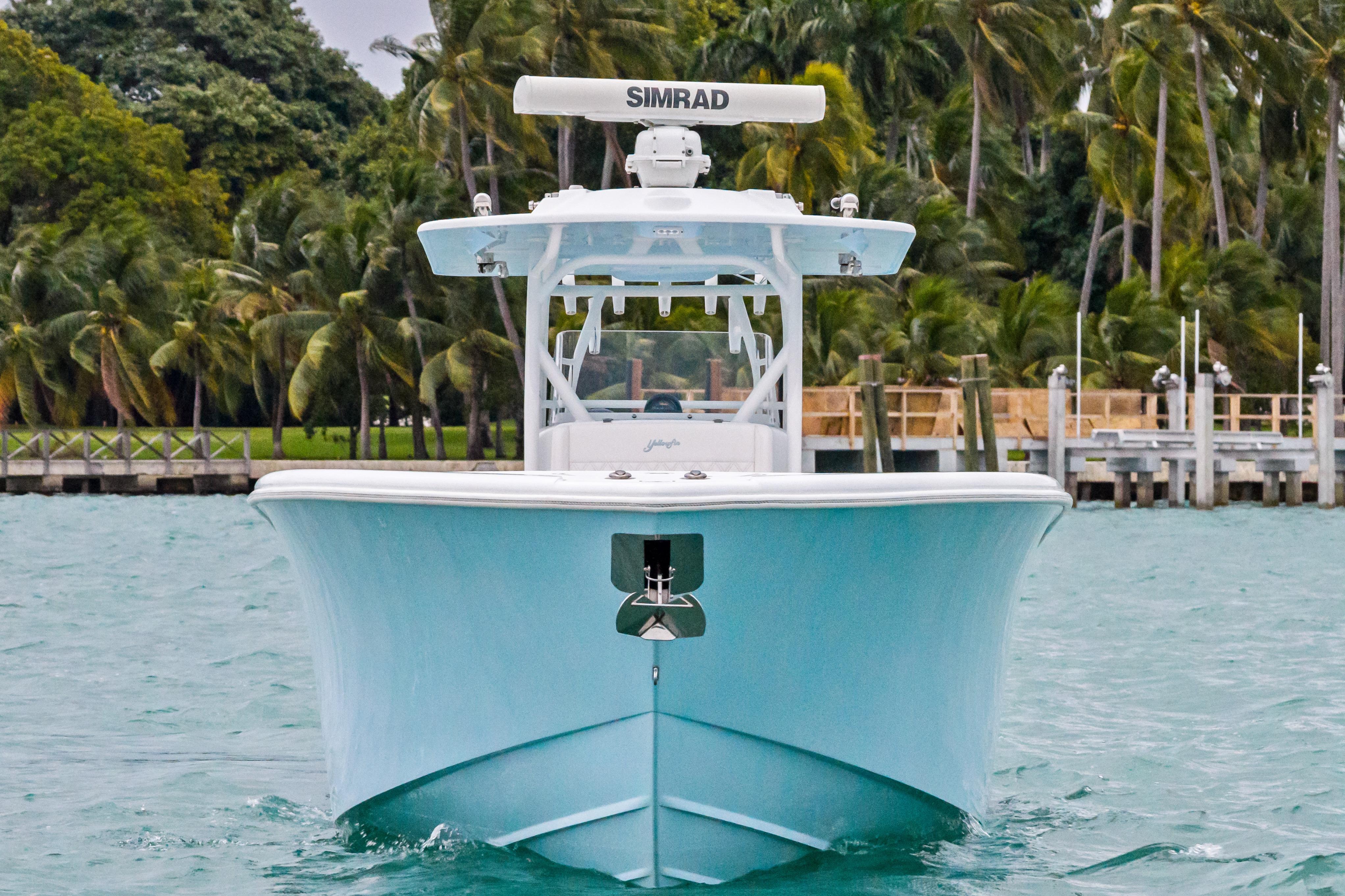 2021 Yellowfin 36 Offshore boat on water, surrounded by palm trees.