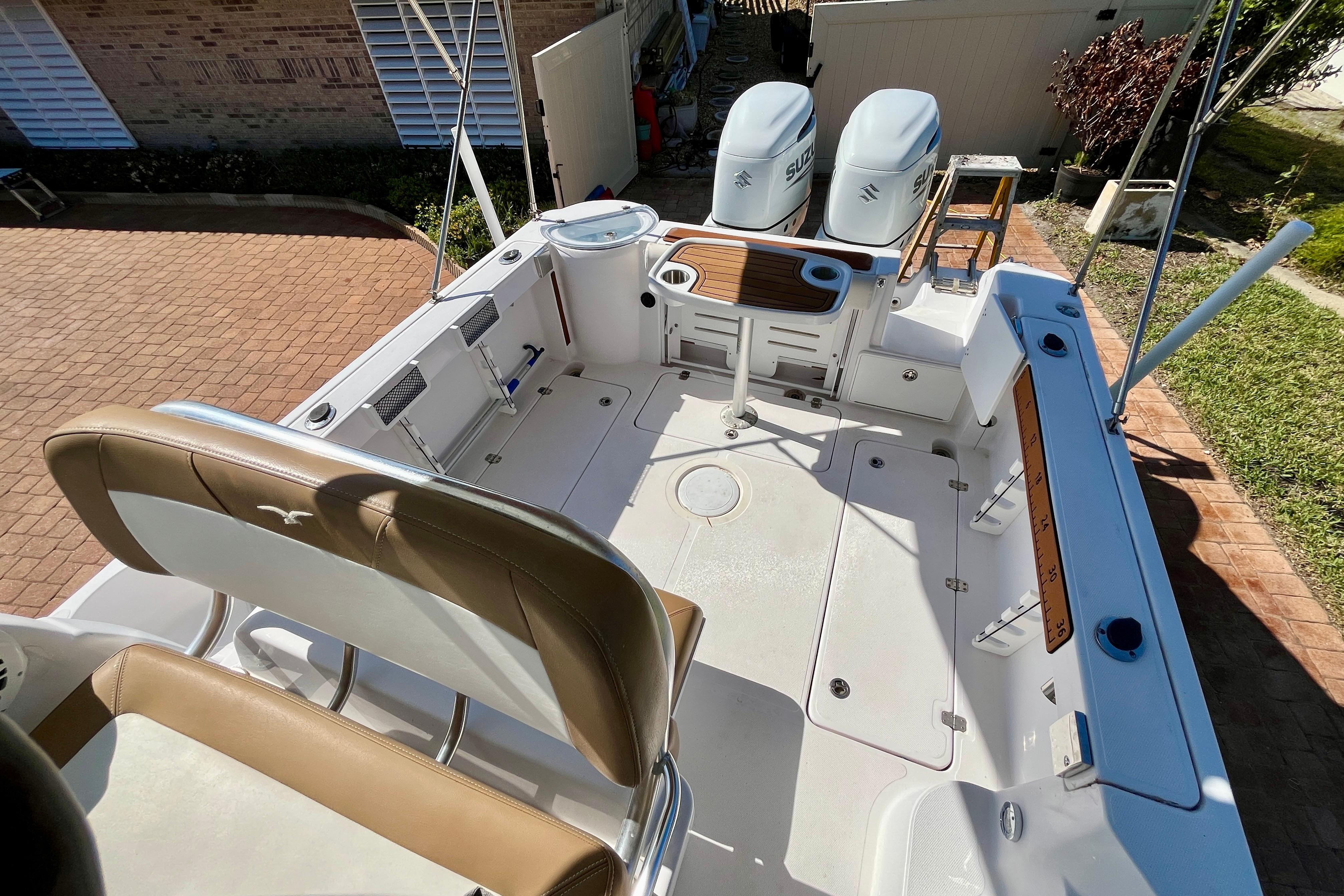 2018 Pro-Line 26 Express boat deck with seating, dual engines, and fishing rod holders.