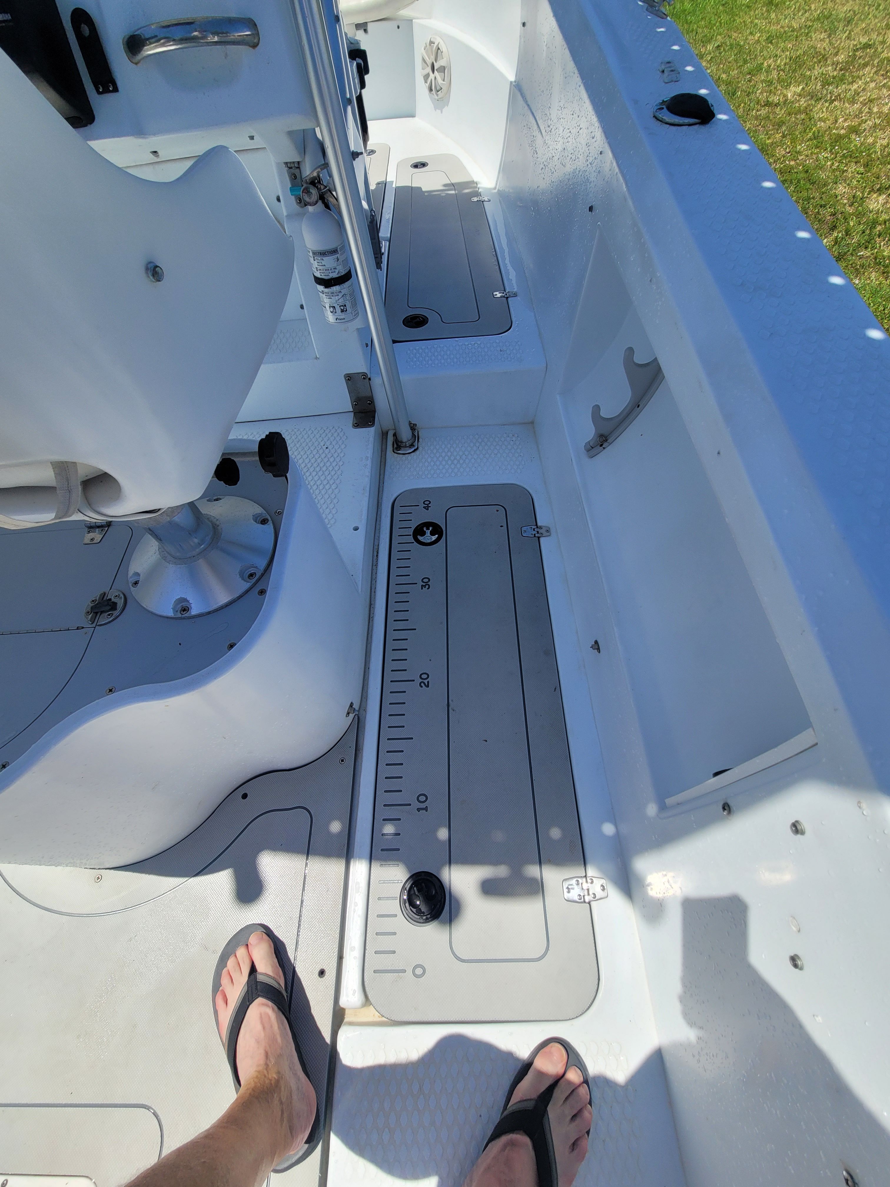 The image shows the deck of a 2005 Triumph VS boat with a ruler on the floor.