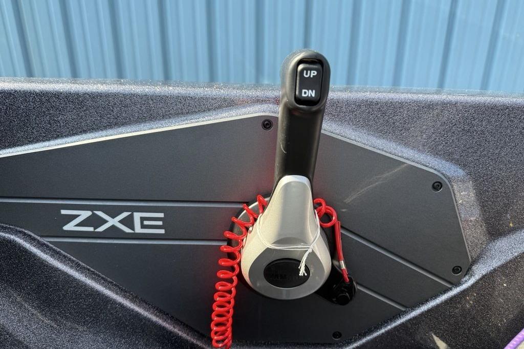 Control panel of 2026 Skeeter ZXE20 boat with throttle lever and red safety cord.