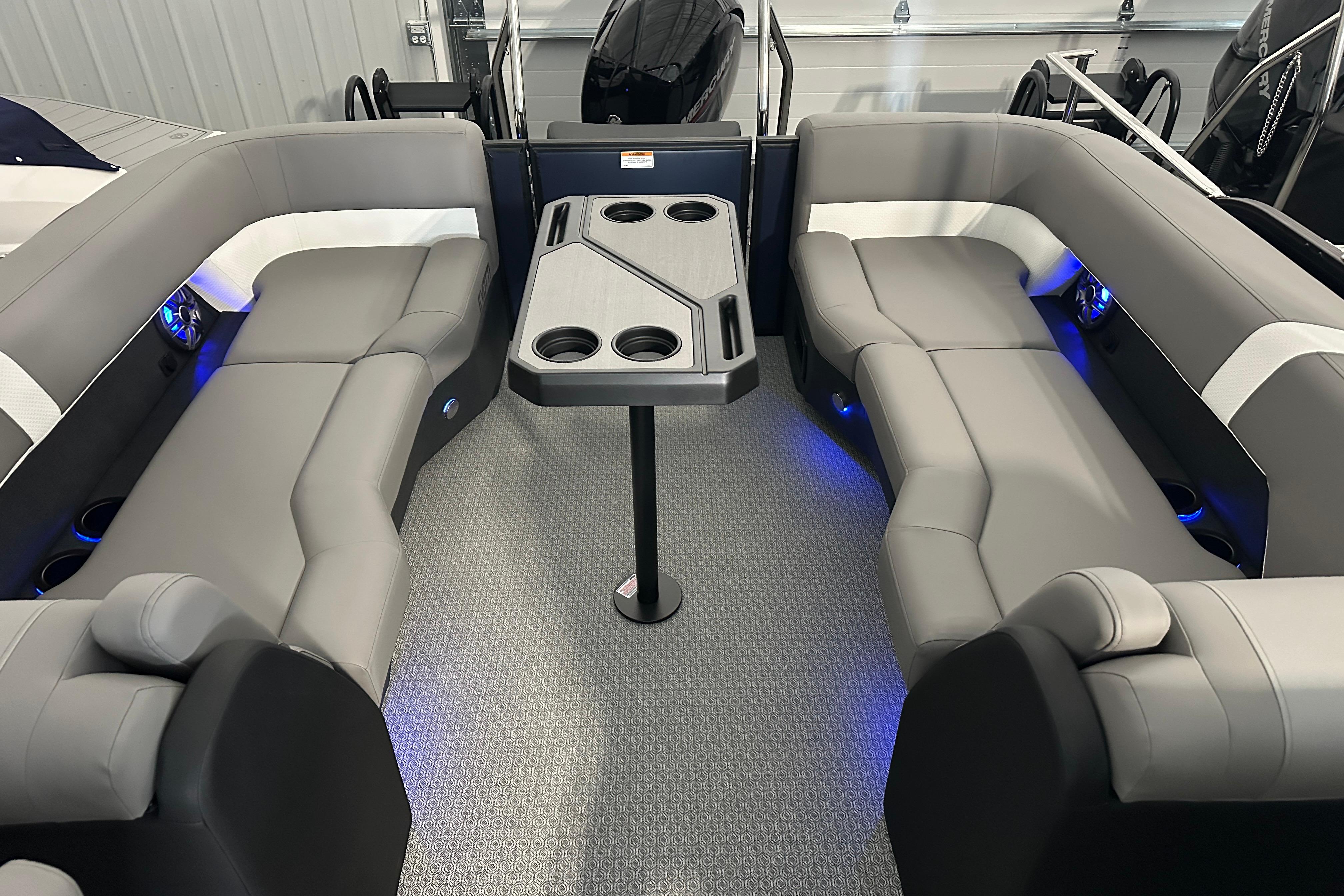 Luxurious interior of 2026 Evotti 523QL boat with gray seating and modern table design.