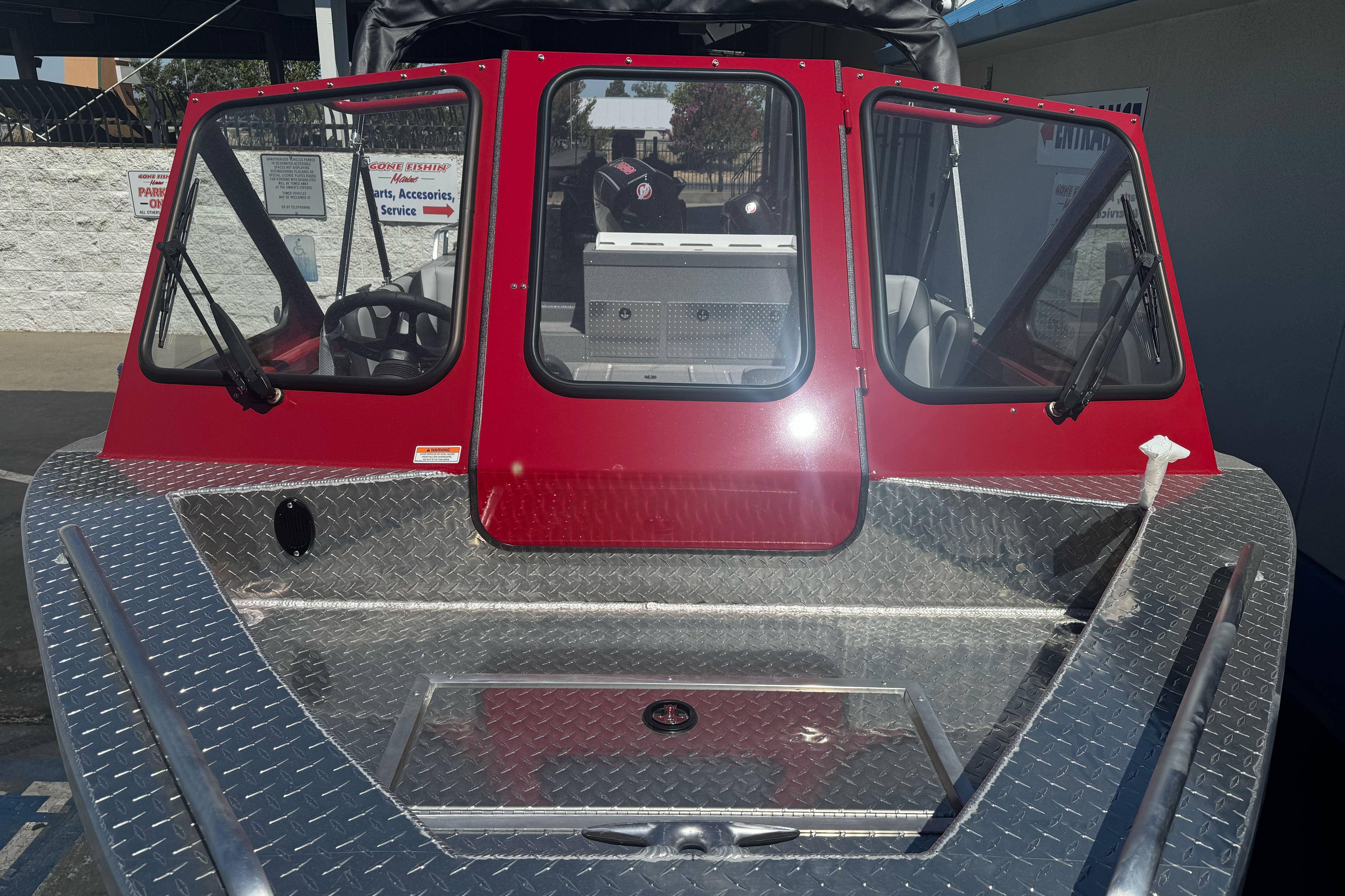 2026 Lund 210 Heavy Gauge boat with red cabin and diamond plate deck.