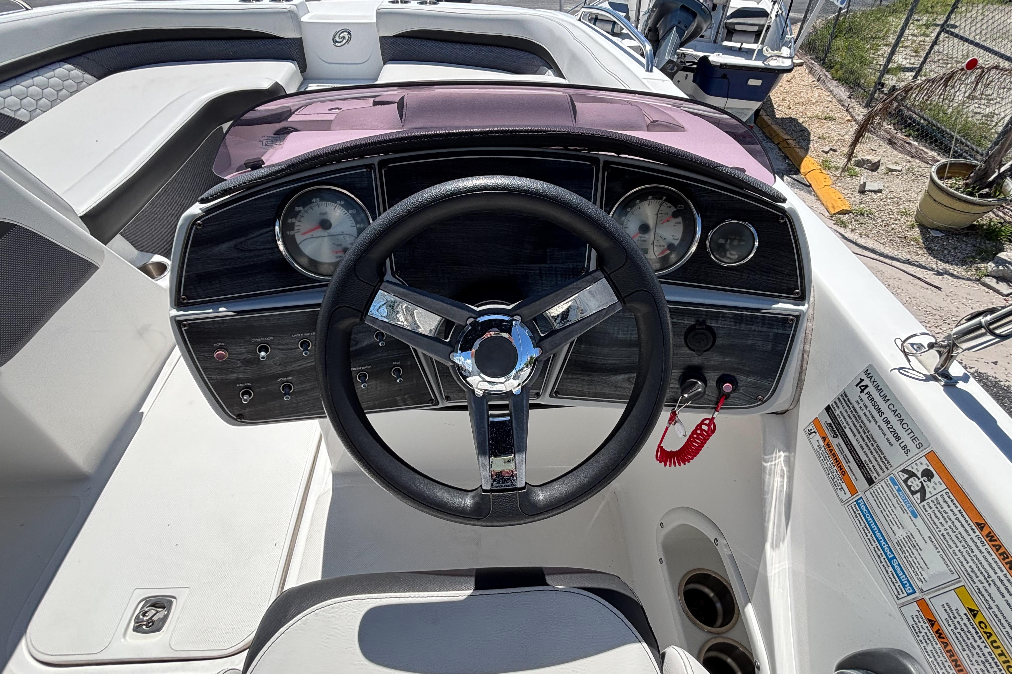 2019 Hurricane Sundeck Sport 218 OB boat dashboard with steering wheel and gauges.