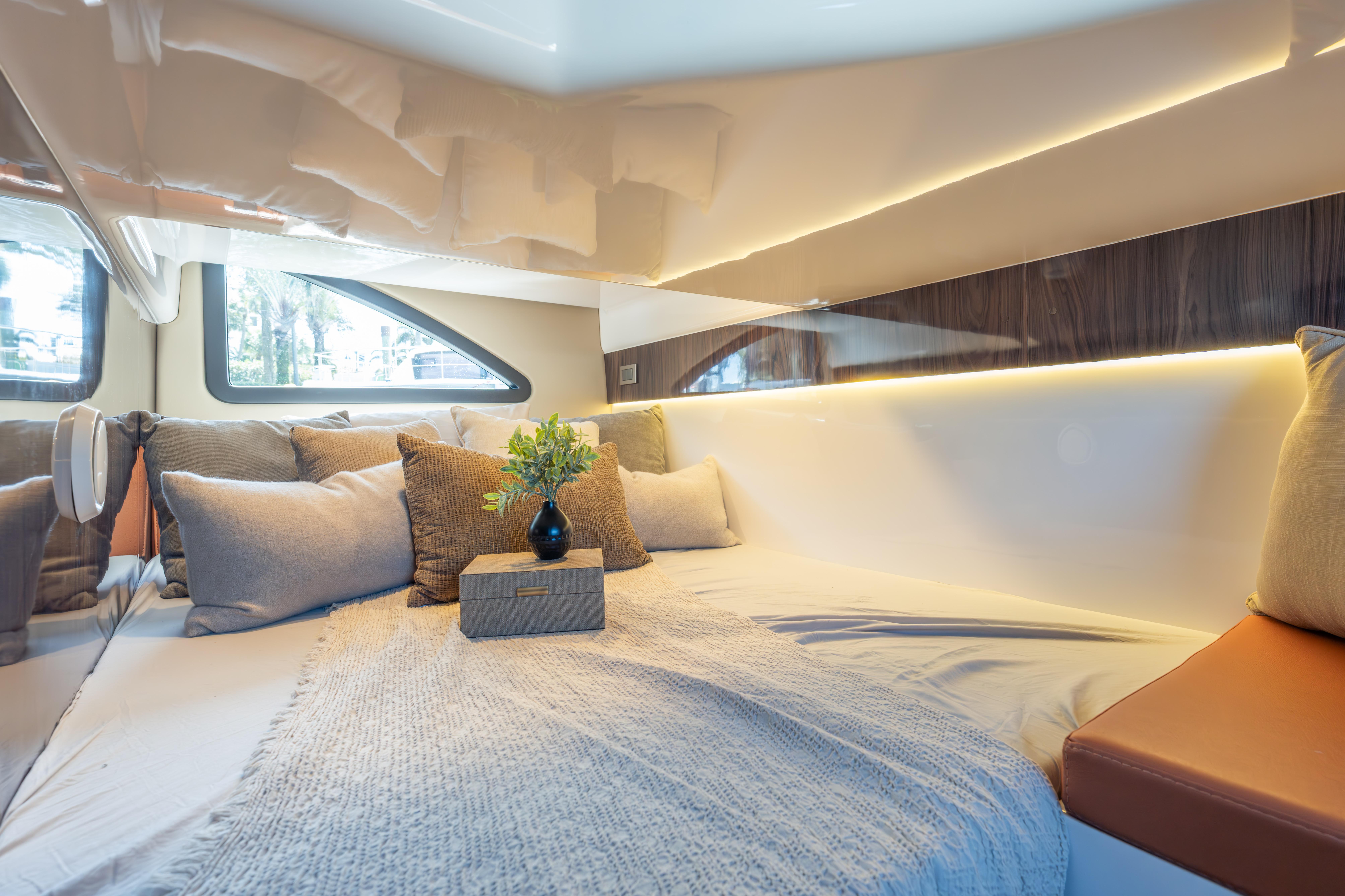 Luxurious interior cabin of 2026 Hanover 387 yacht with cozy bedding and elegant decor.