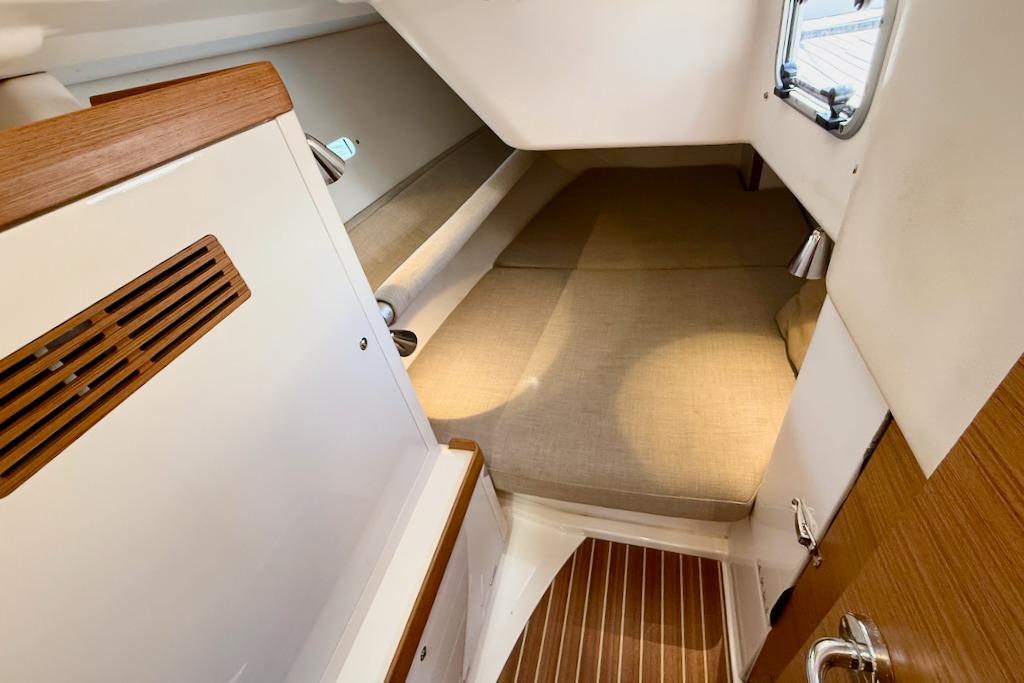 Cozy cabin interior of 2016 X-Yachts Xp38 with wooden accents and comfortable bedding.