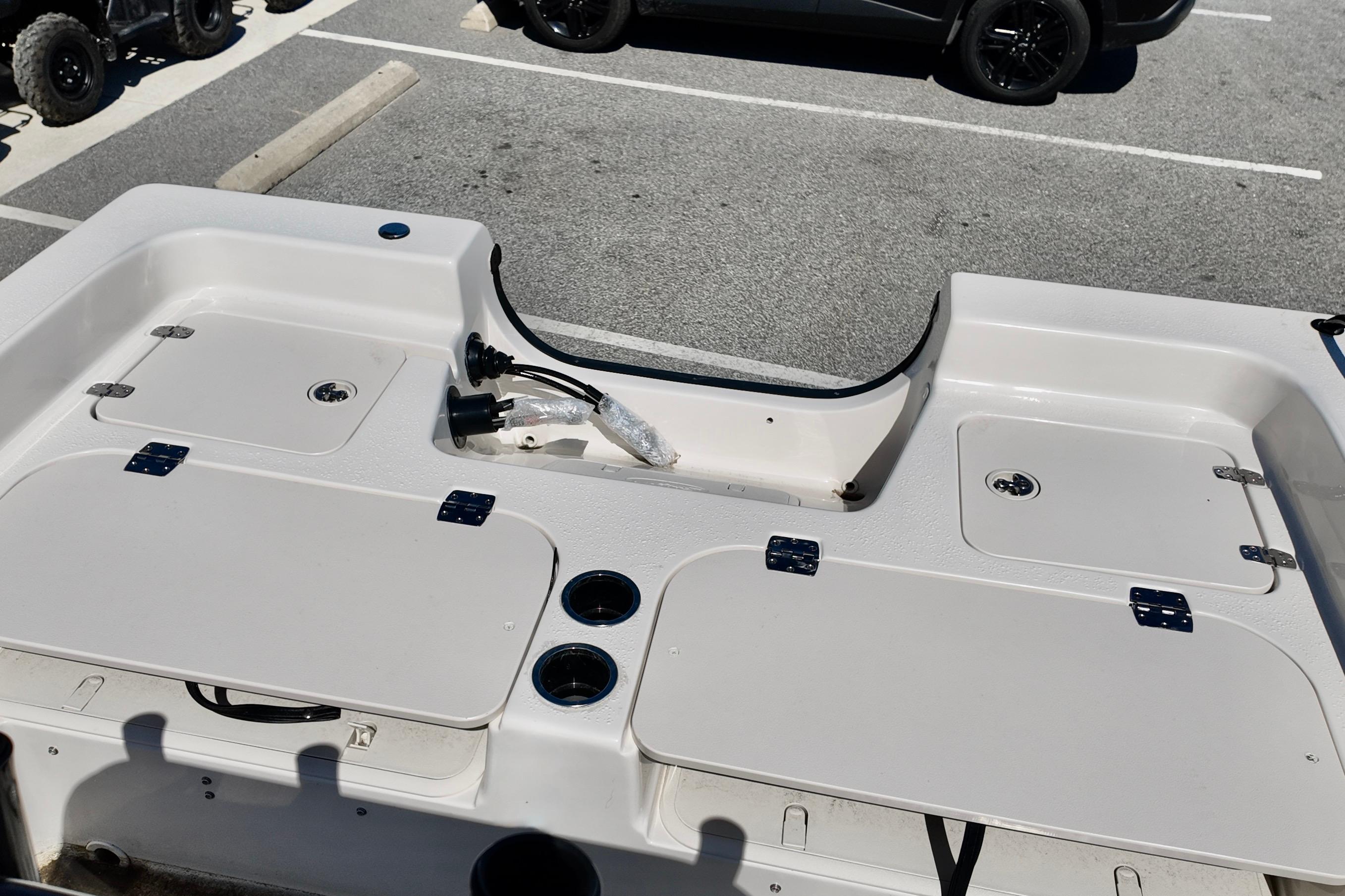 2026 Carolina Skiff 21 Ultra Elite boat deck with storage compartments and cup holders.