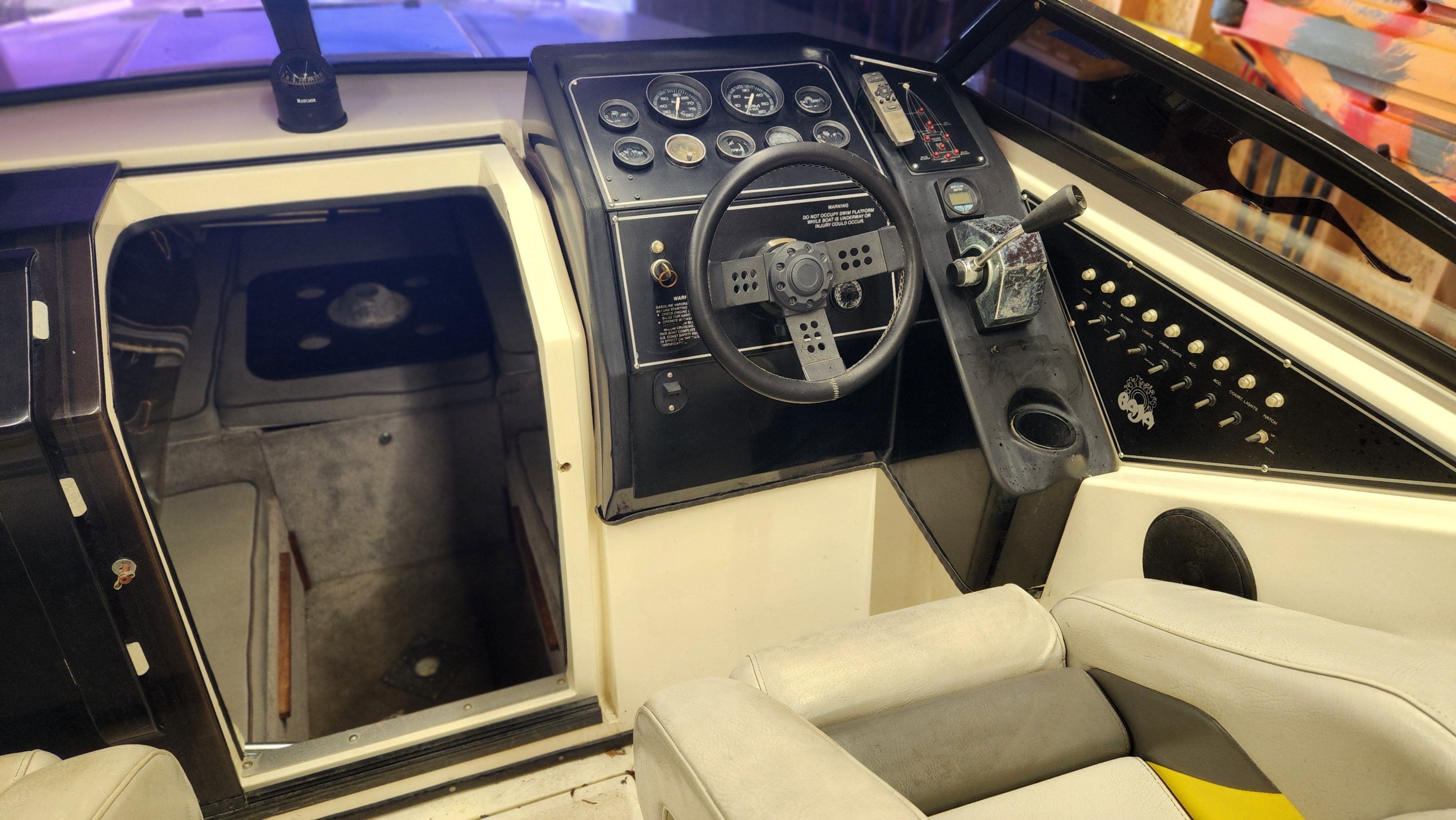 Interior view of a 1989 Baja FORCE 235 with helm and instruments.