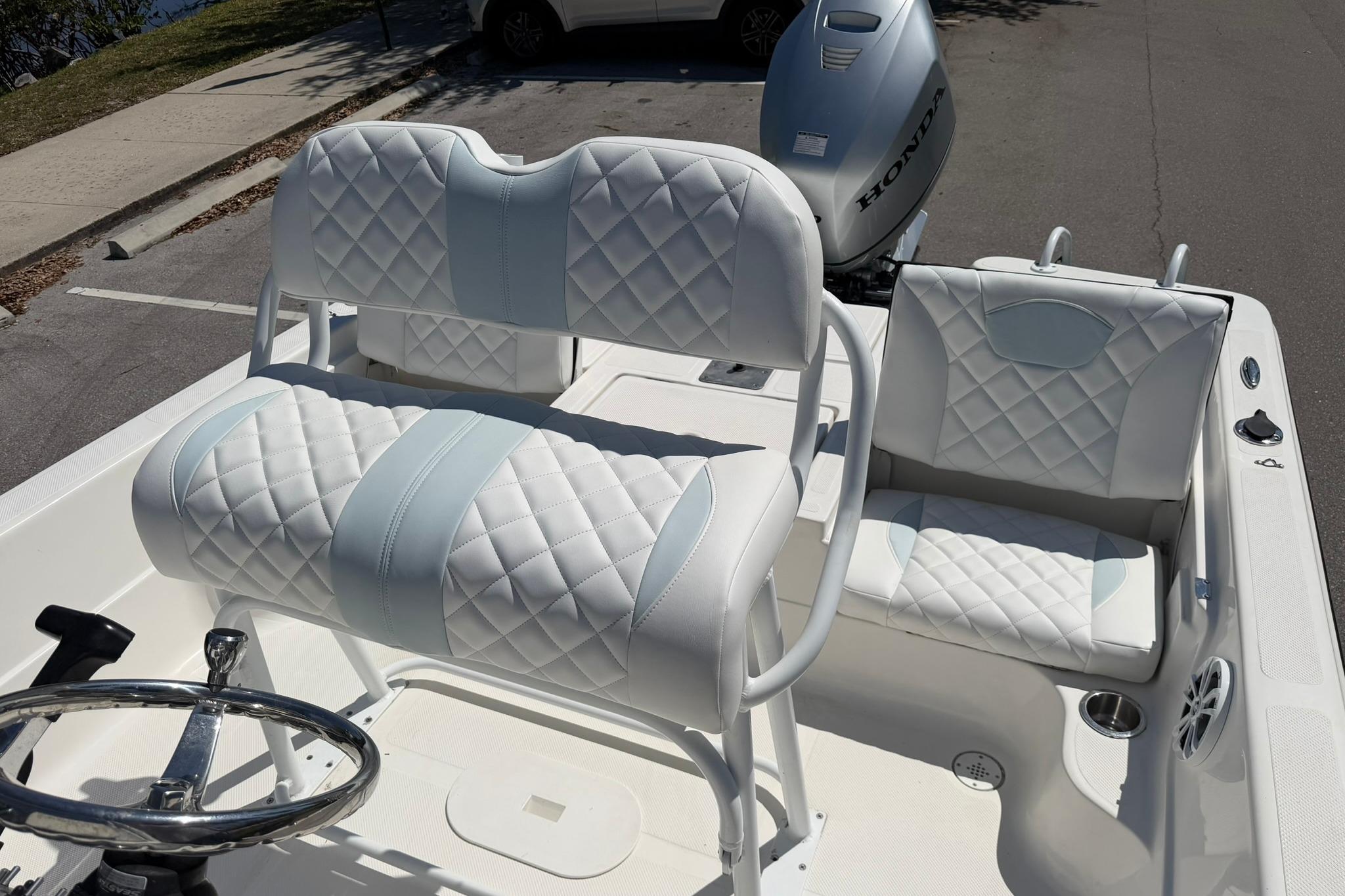 2018 Epic 22SC boat interior with quilted white seats and Honda outboard motor.