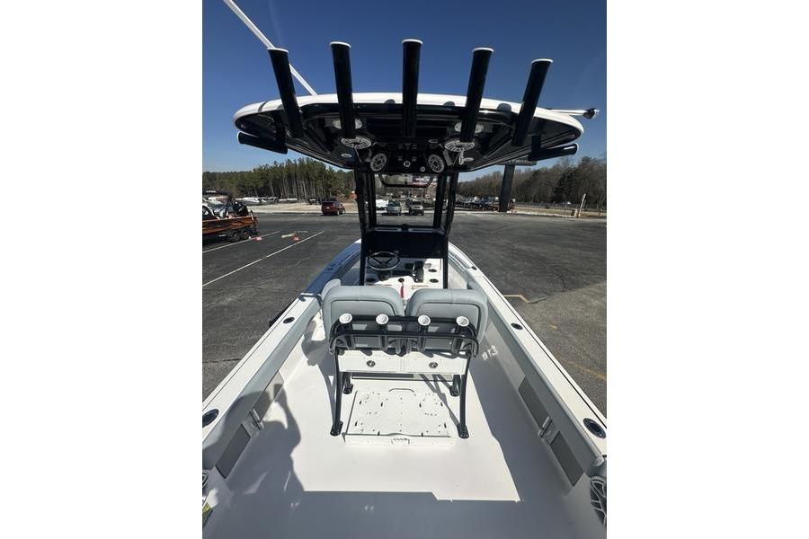 2026 Sportsman Masters 247 Bay Boat with T-top and dual seating, parked outdoors.