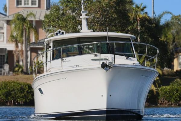 2025 Sabre 43 Salon Express yacht cruising on a serene waterway.