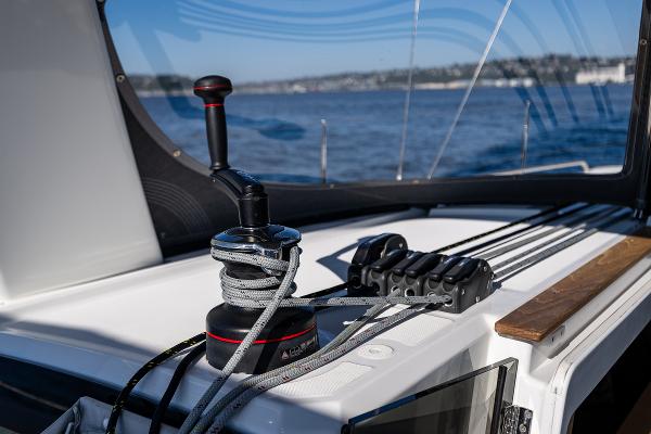 Beneteau Oceanis 38.1, 2021, sailboat deck with winch and ropes.