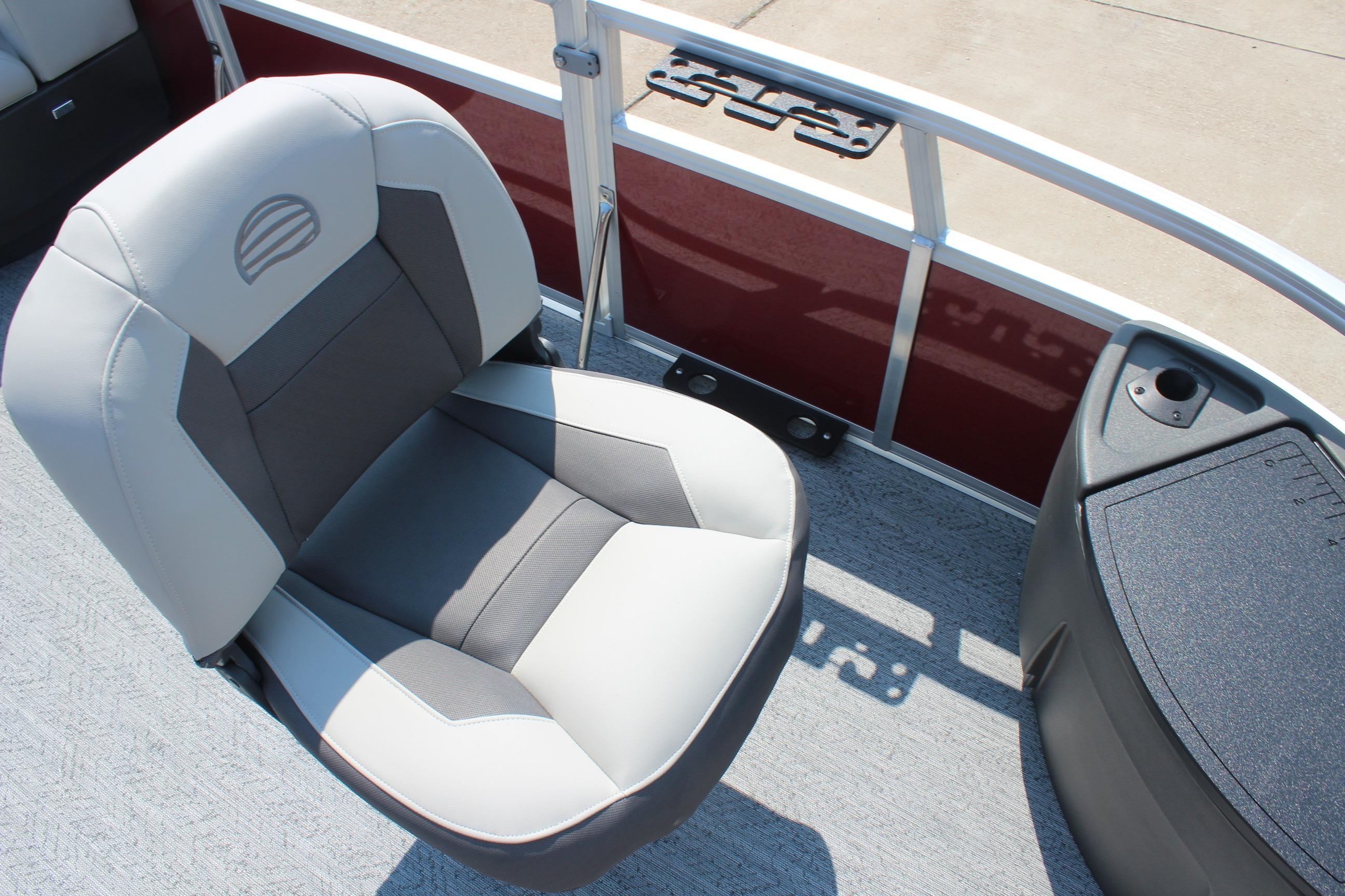 2026 Sun Tracker Bass Buggy 18 DLX boat seat with red paneling and console.