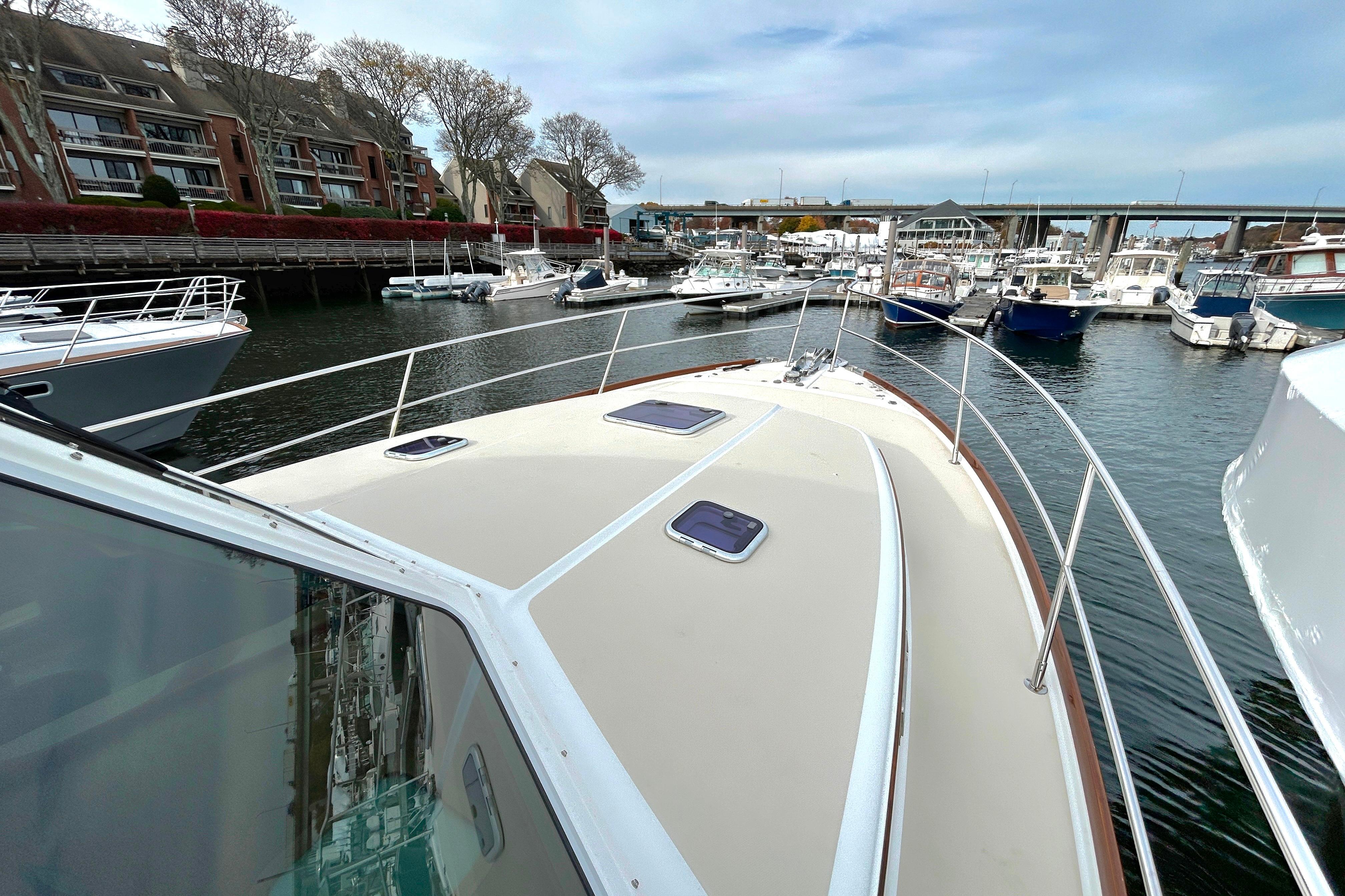 2017 Sabre 42 Salon Express yacht docked in a marina with surrounding boats.