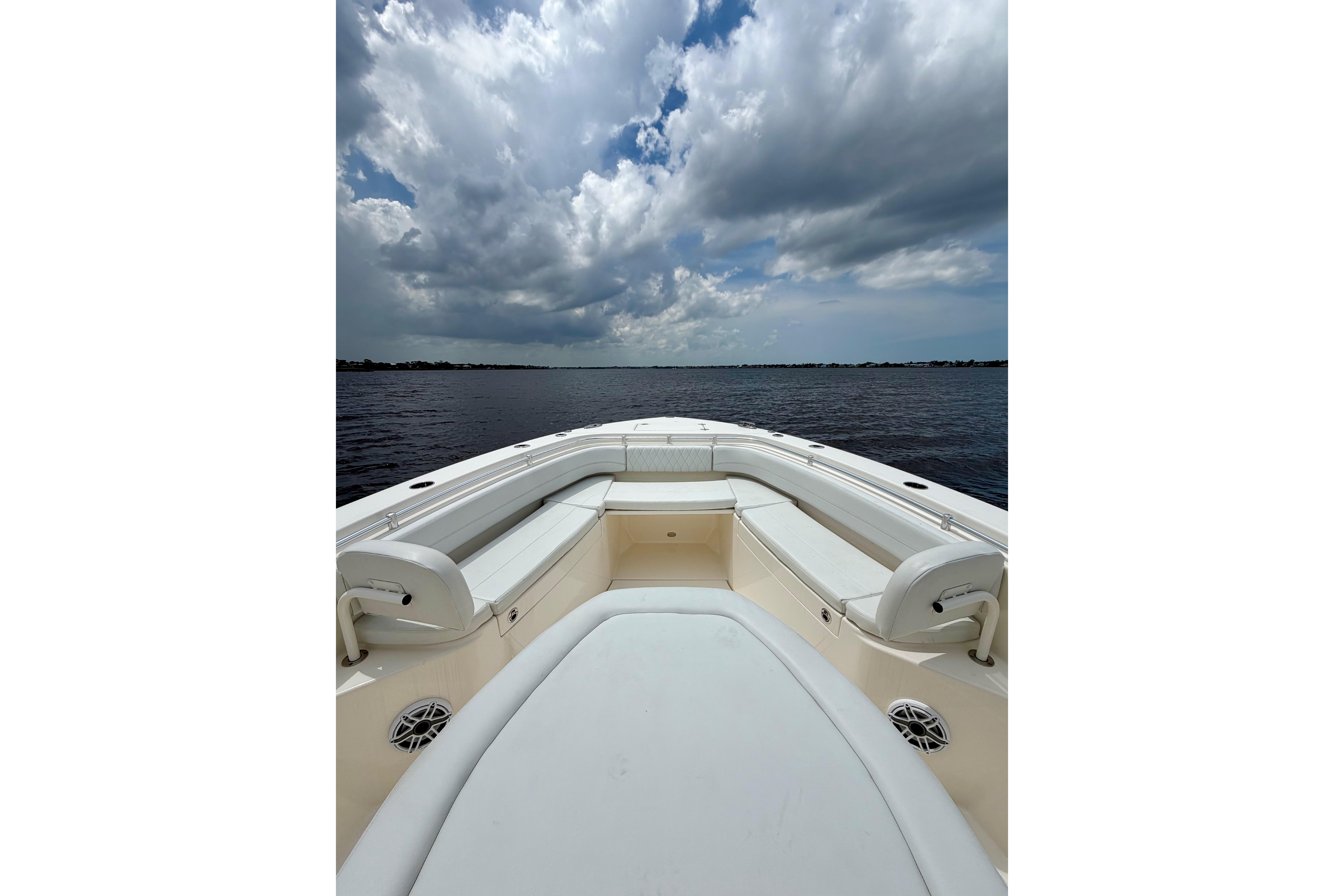 2023 Cobia 350 Center Console boat on open water under cloudy sky.