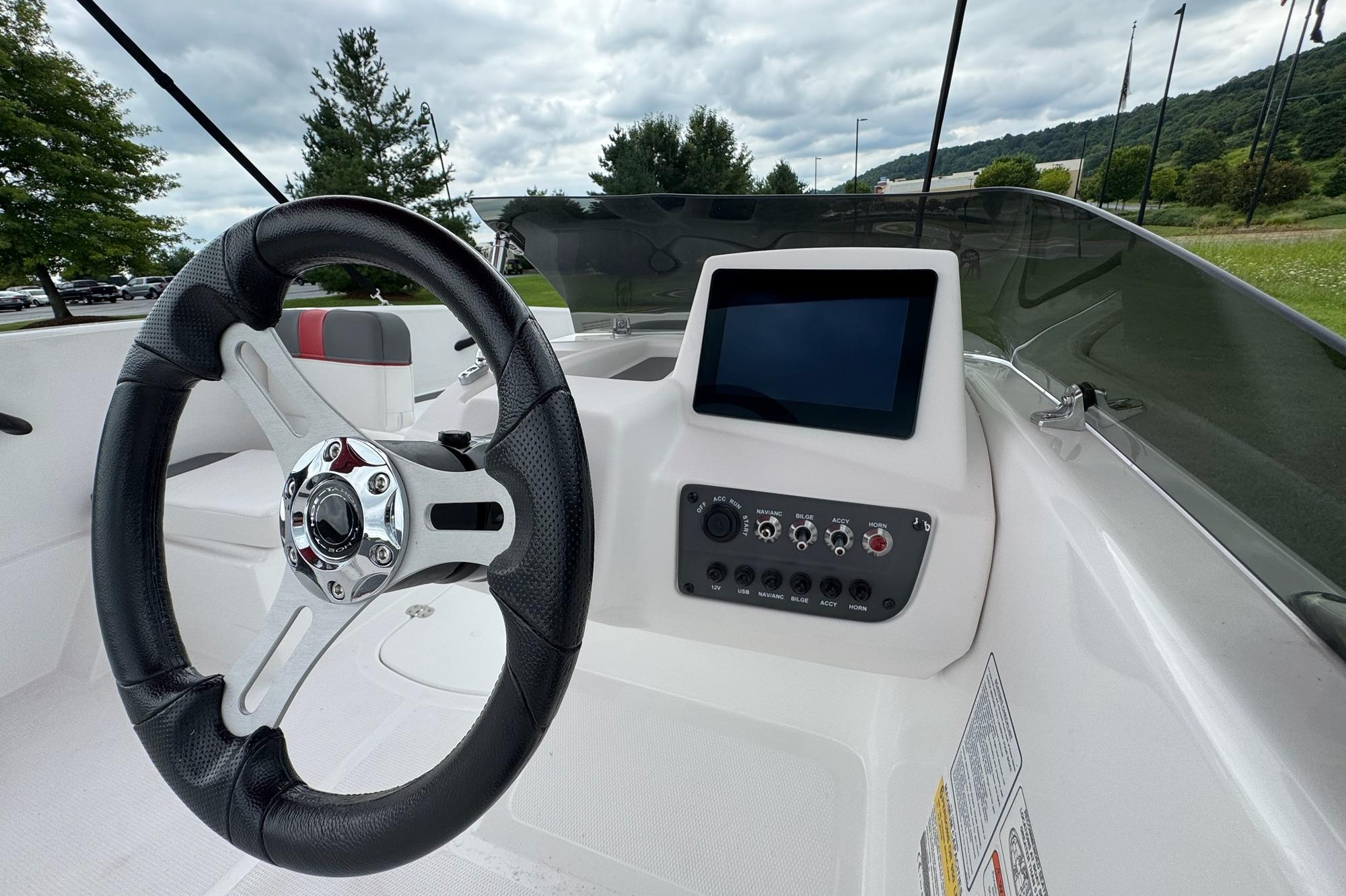 2026 Tahoe T16 boat dashboard with steering wheel and control panel.