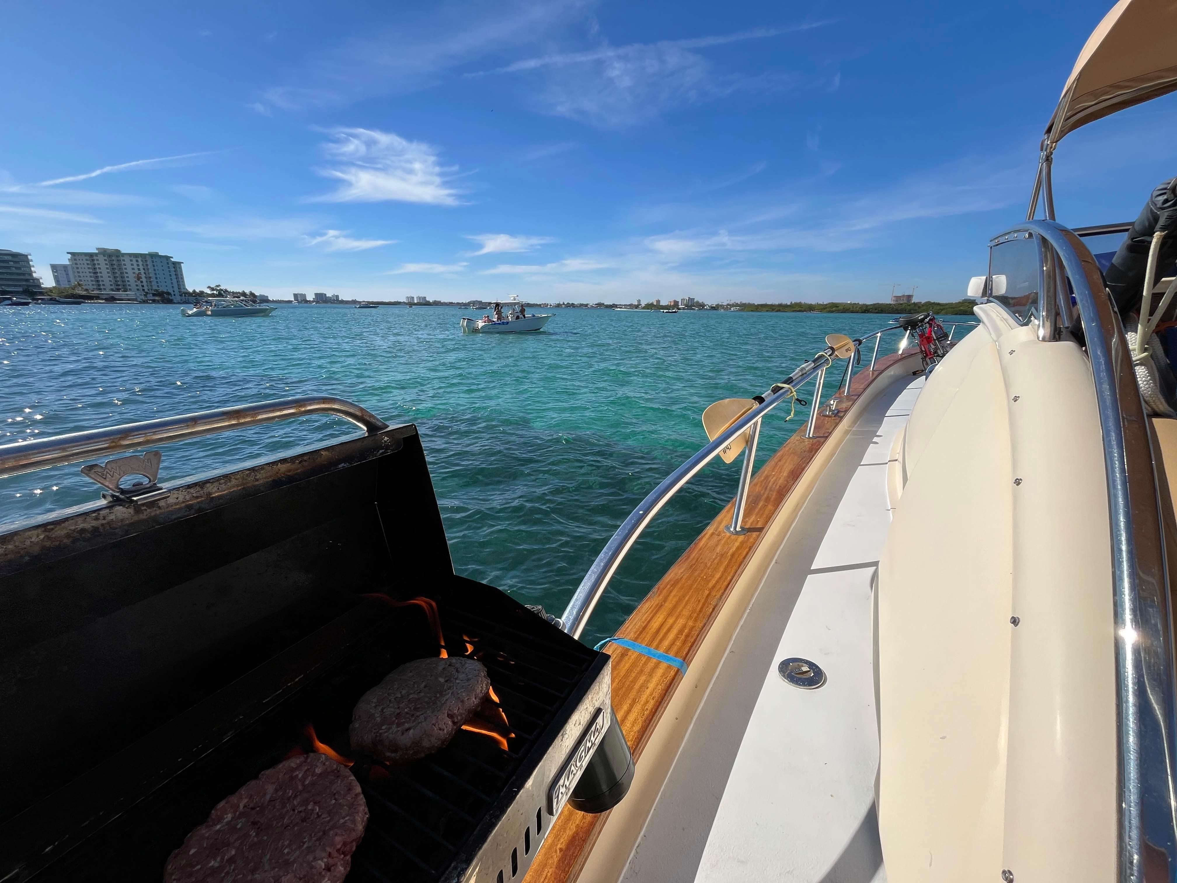 2005 Apreamare Don Giovanni yacht with grill, cruising on clear blue waters under a sunny sky.