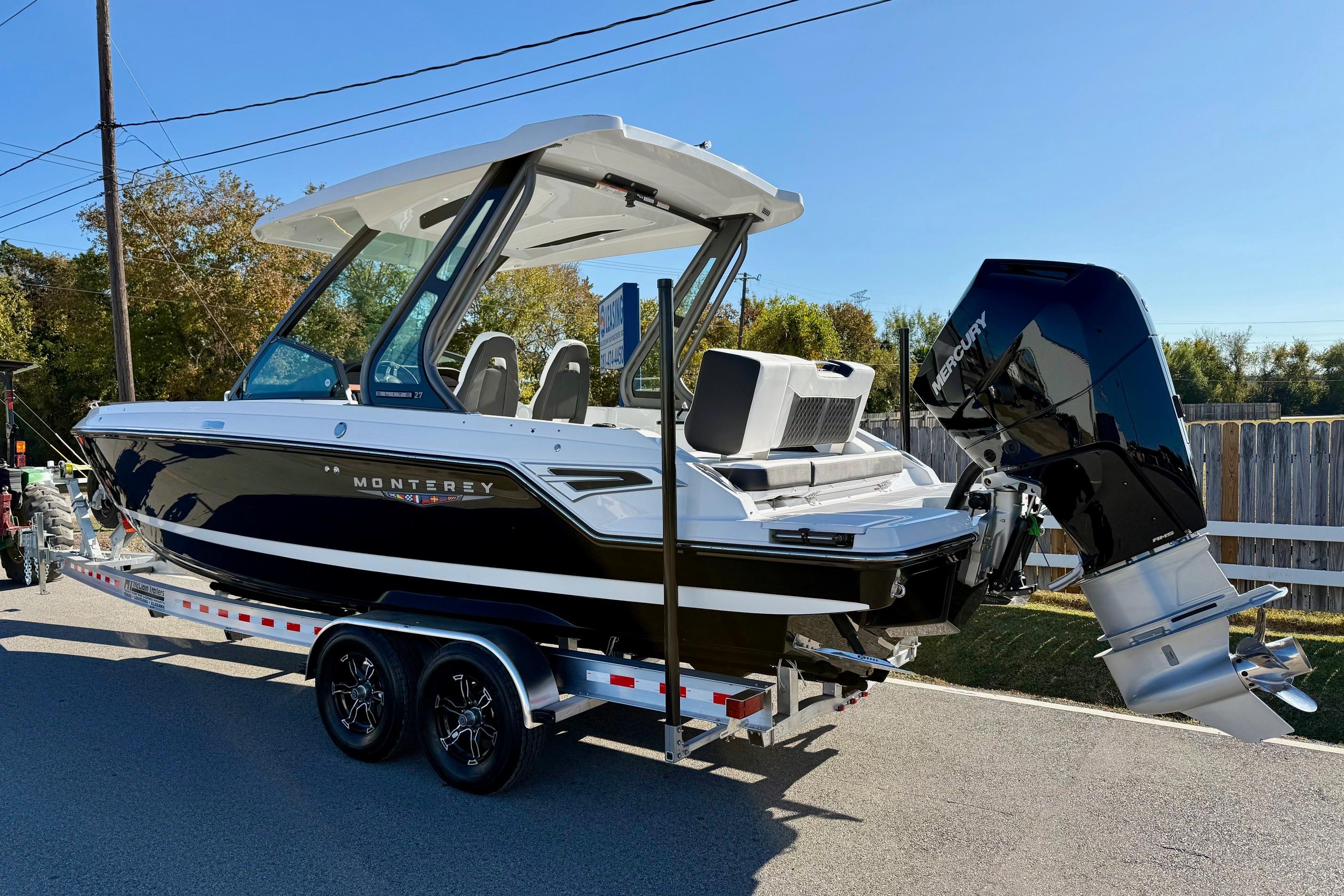 2026 Monterey Elite 27 OB boat on trailer, outdoor setting.