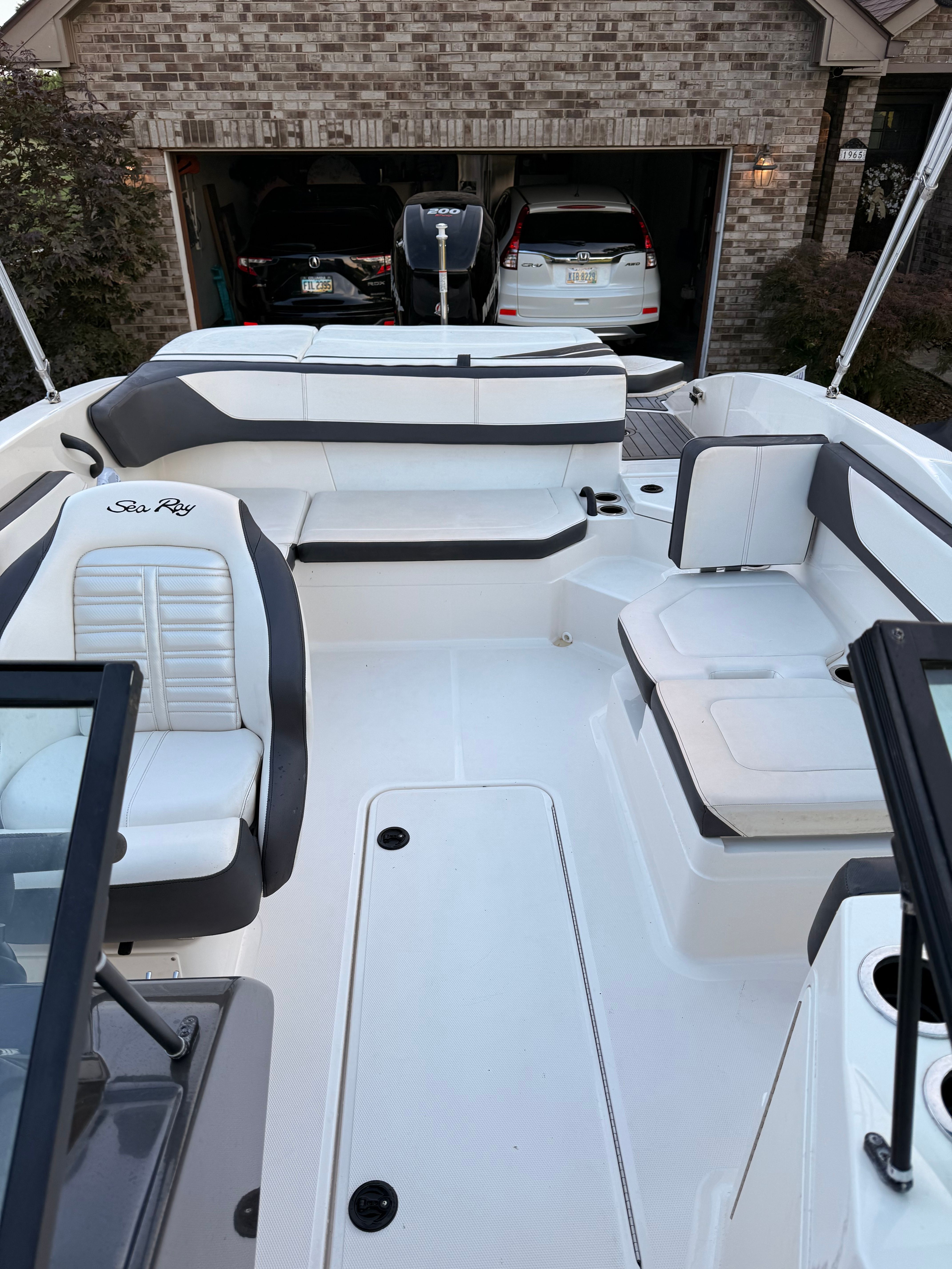 The image shows the cockpit of a 2016 Sea Ray SPX 210 Outboard with white and gray seating.