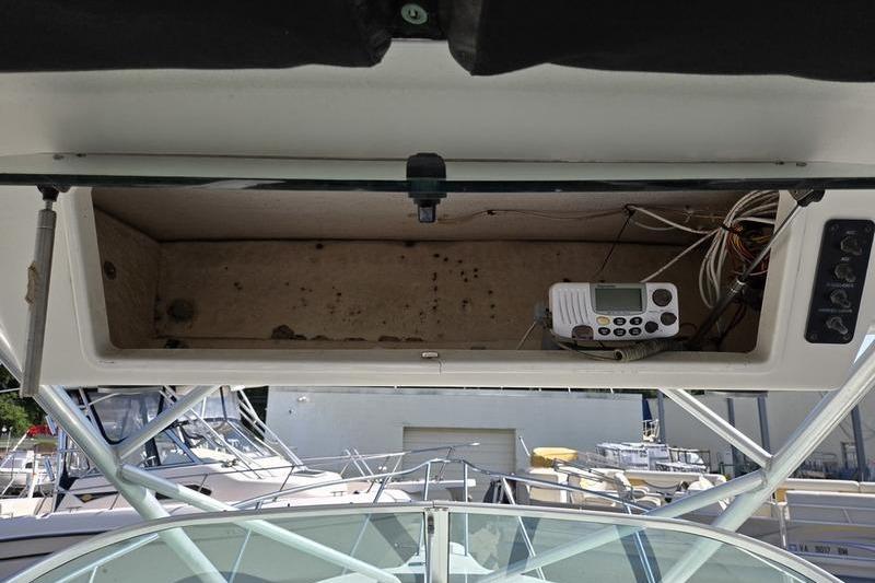 2004 Robalo R235 Walkaround boat dashboard with open storage compartment and electronic device.