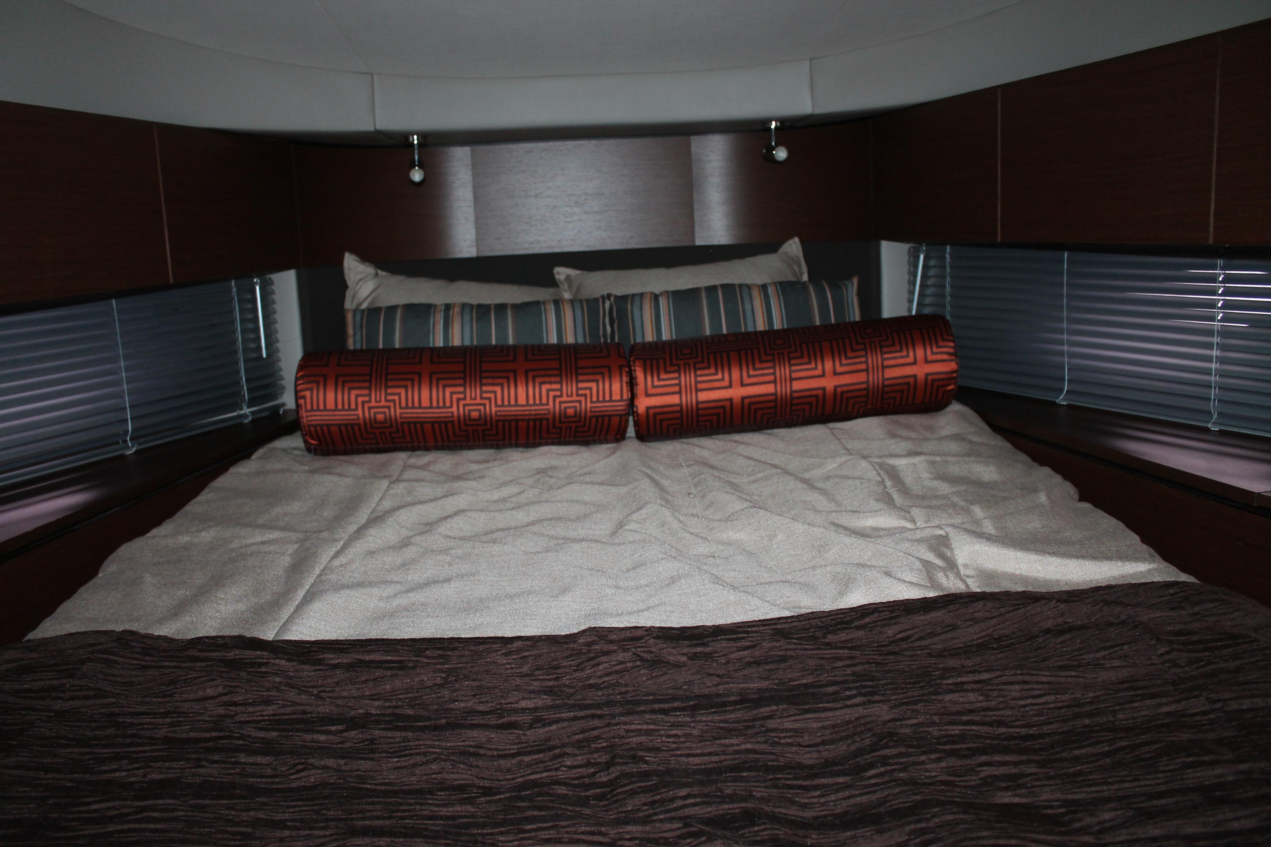 Luxurious cabin interior of 2015 Sea Ray 470 Sundancer yacht with elegant bedding.