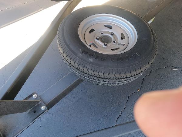 Spare tire on a 2024 Sun Tracker Fishin' Barge 22 XP3 trailer.