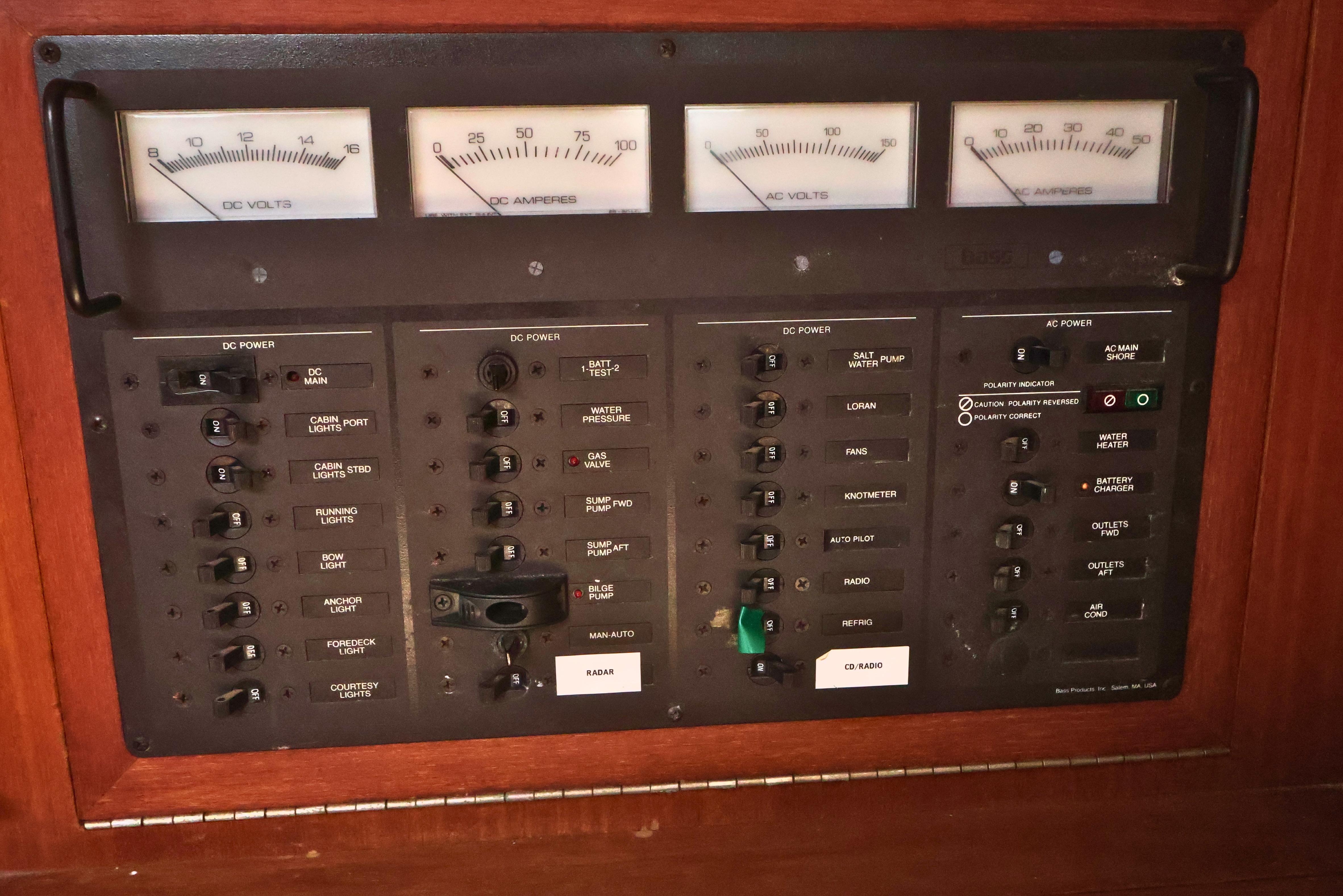 Electrical control panel on a 1989 J Boat J 40, featuring voltage and amperage gauges.