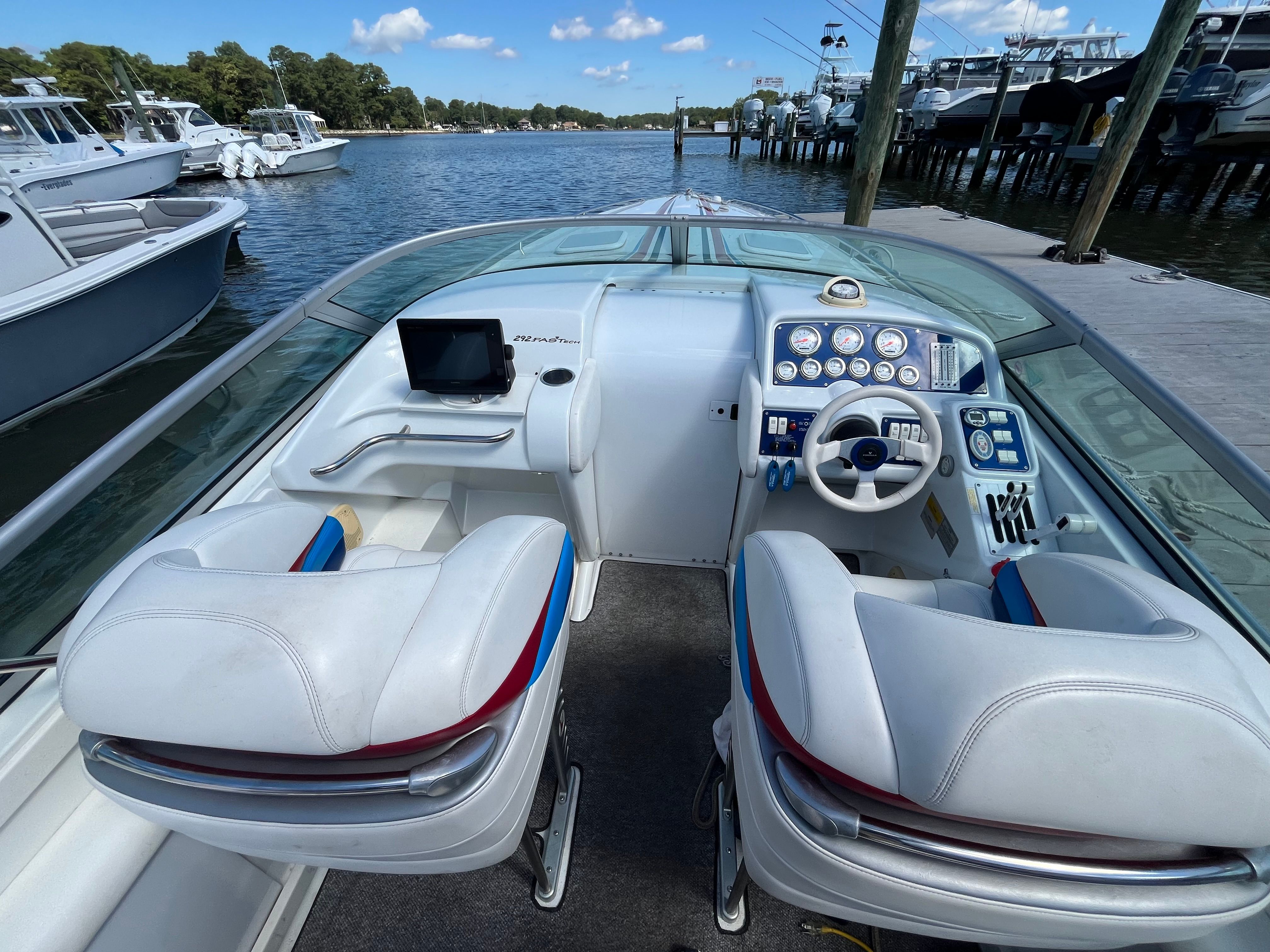 The image shows the cockpit of a 2004 Formula 292 FASTech boat with two seats and a helm.