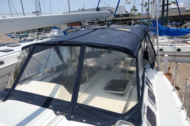 Hunter 460 sailboat, 2000 model, with blue canvas cockpit cover in marina.