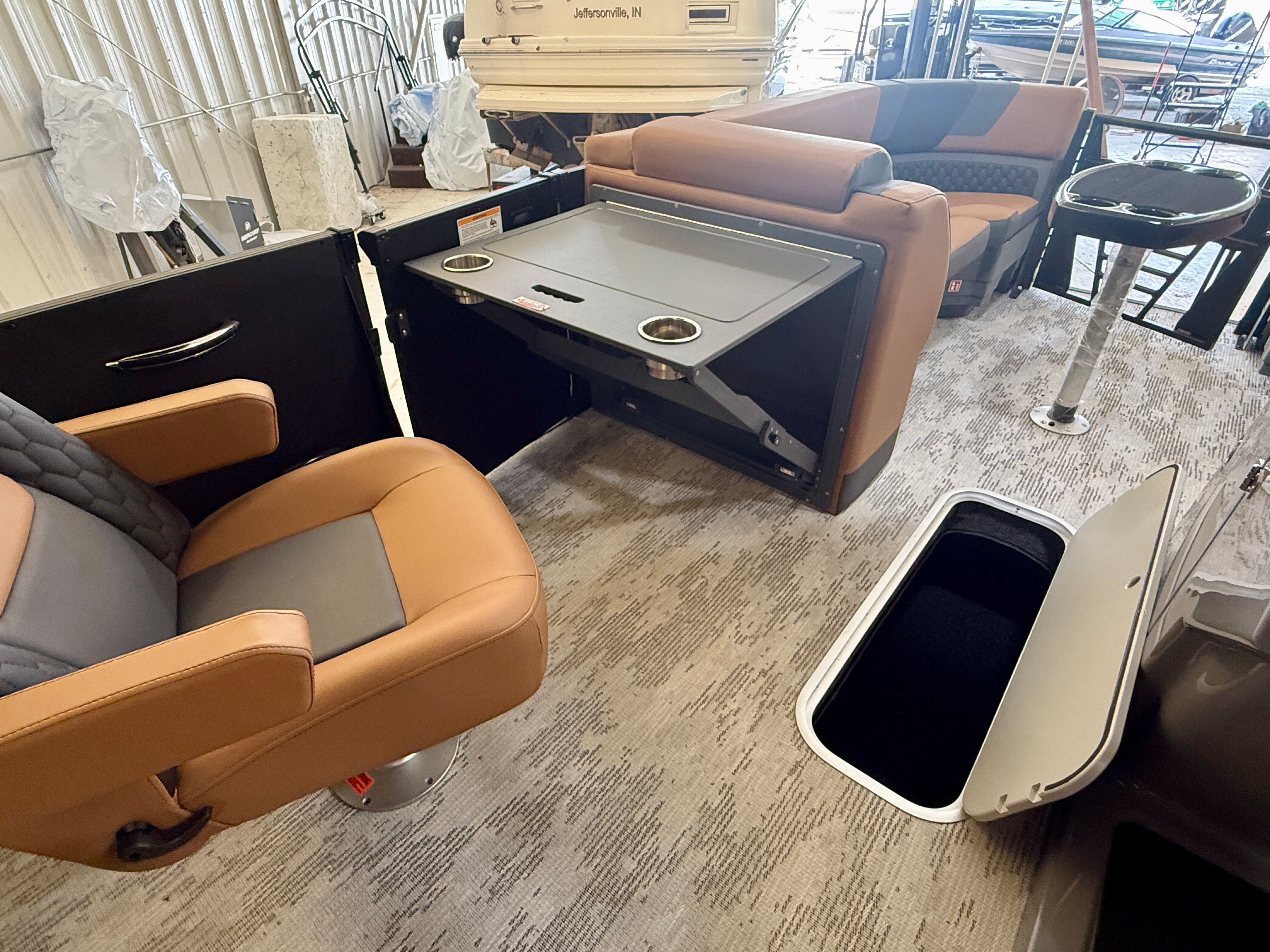 Interior of a 2026 Sylvan L3 ULZ DH with beige and gray seating and a table.