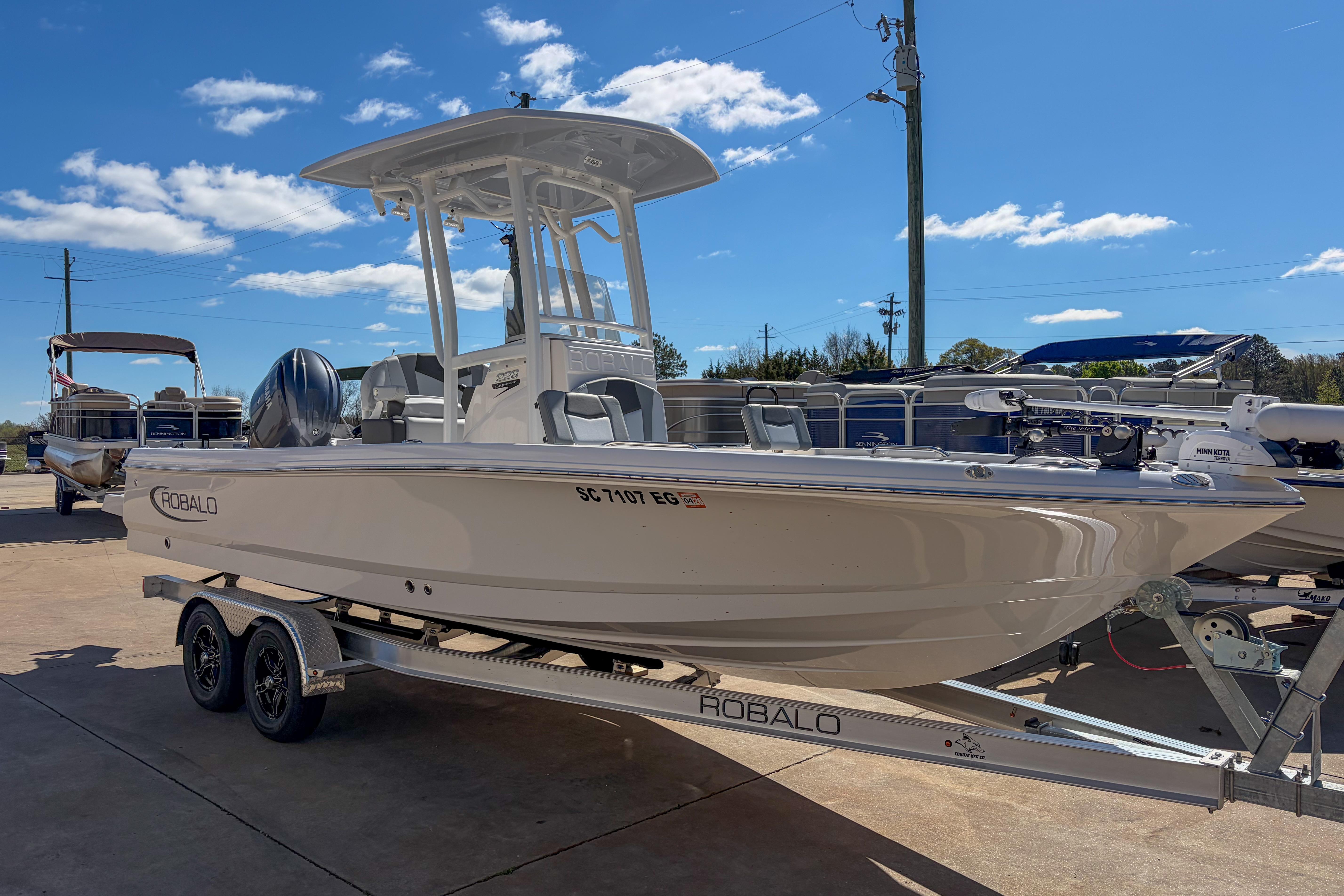 2025 Robalo 226 Cayman boat on trailer under clear blue sky.