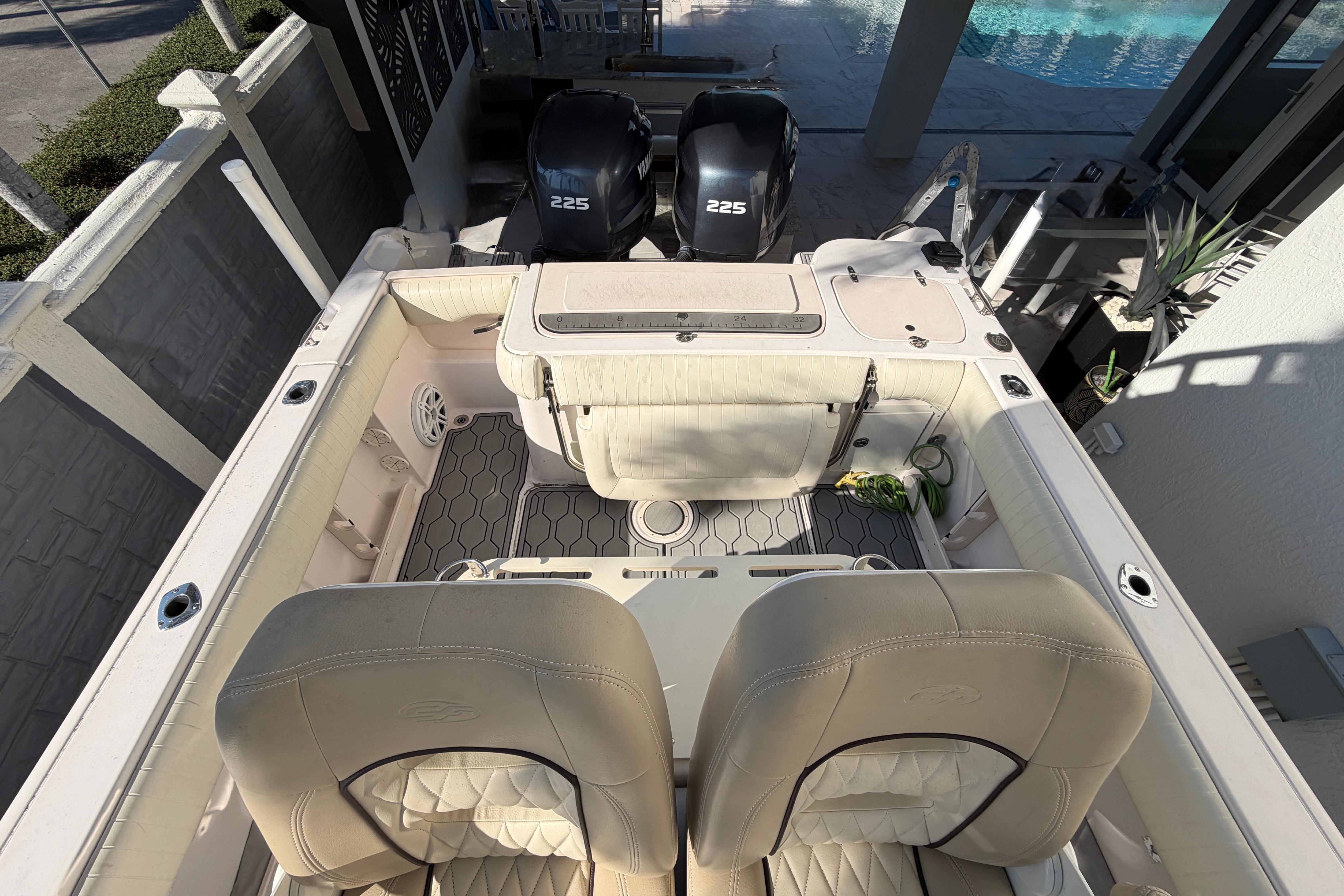 2004 Grady White 273 boat interior with dual 225 engines, beige seating, and deck view.