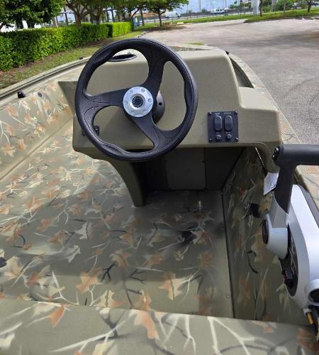 2025 Tracker Grizzly 1648 SC boat interior with camo design and steering wheel.