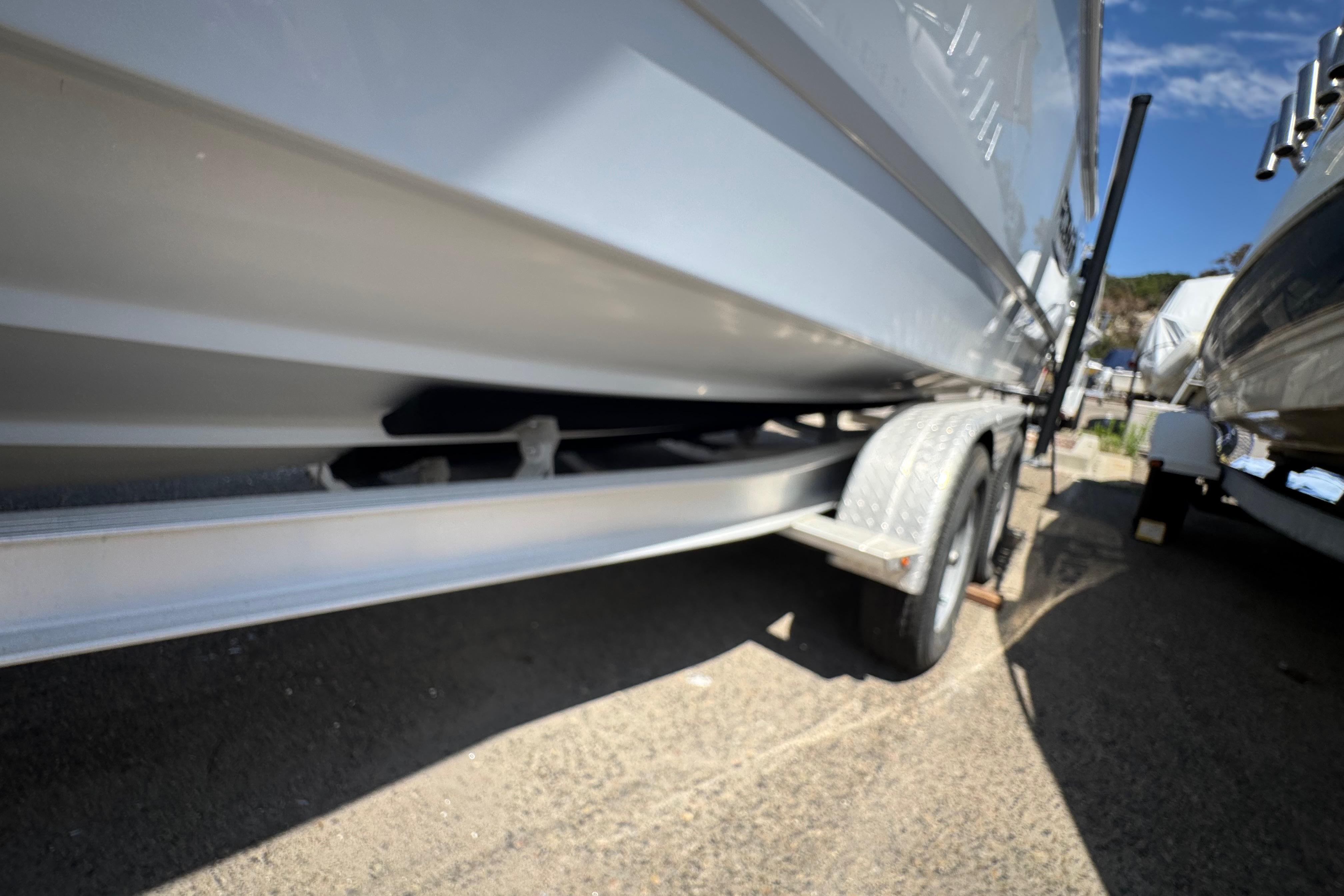 2022 Robalo R230 Center Console boat on trailer, side view, outdoors.