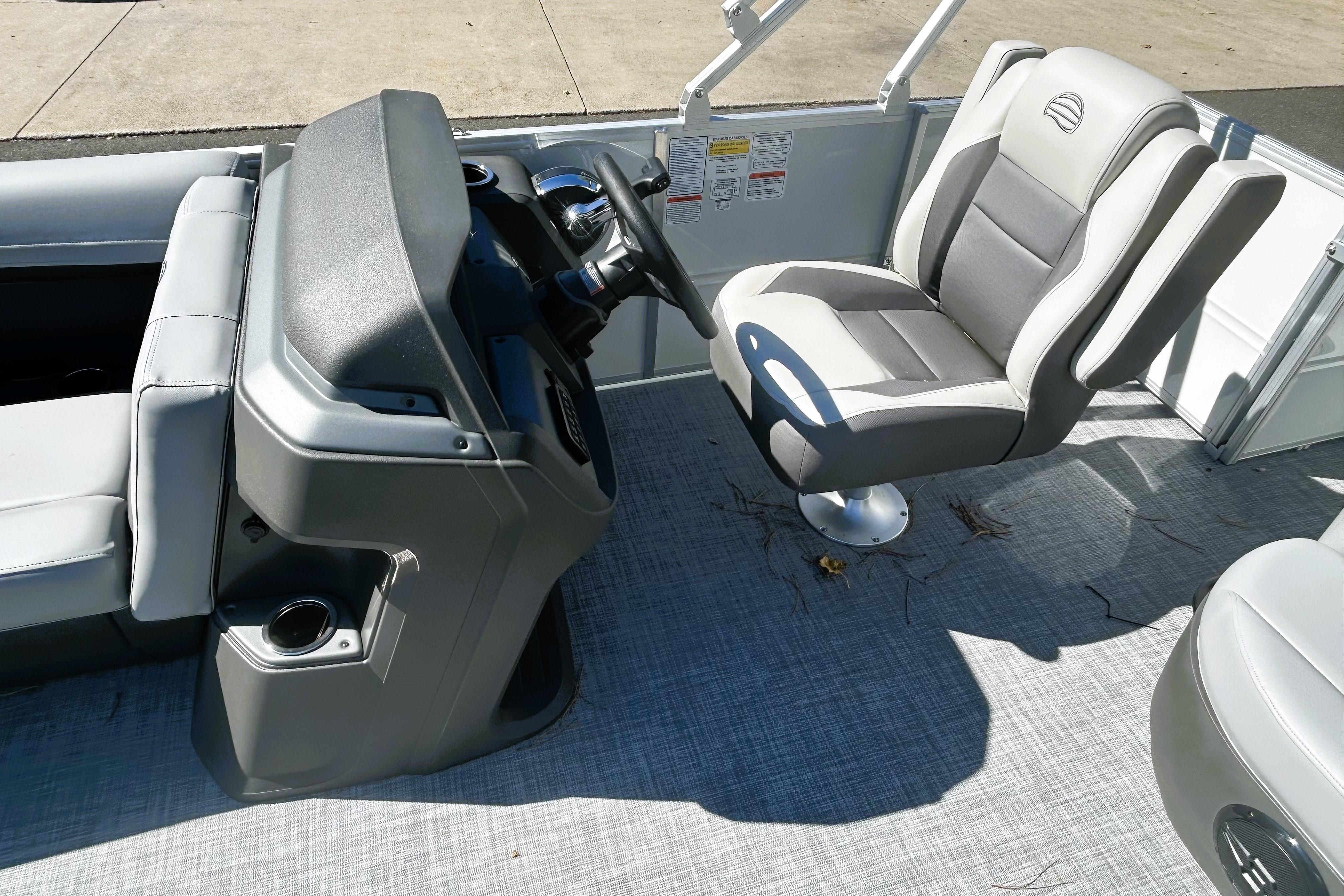2026 Sun Tracker Party Barge 18 DLX interior with steering console and comfortable seating.