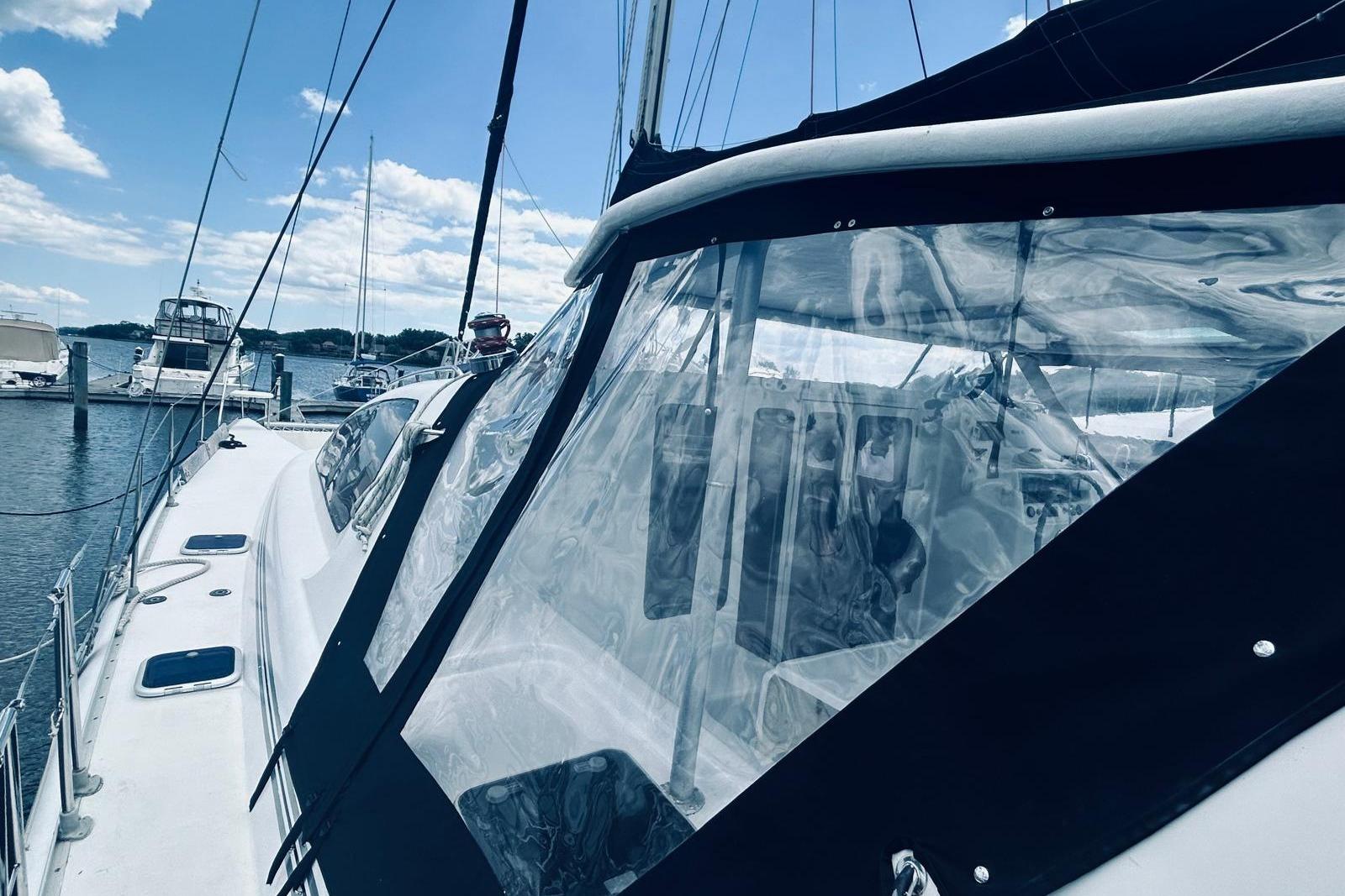 2001 Robertson & Caine Leopard yacht docked, featuring clear canopy and sleek design.