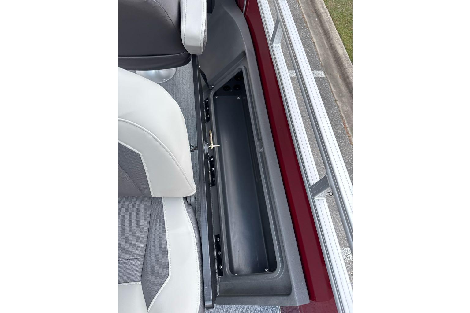 2026 Sun Tracker Fishin' Barge 22 DLX storage compartment and seating detail.